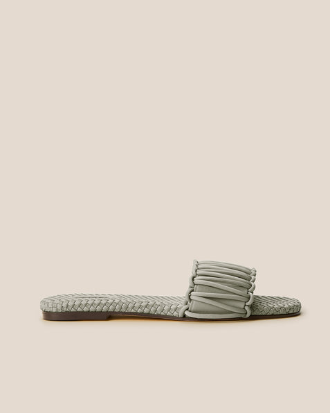 Side view of The Athens Slide in Celadon, a light jade green tone, featuring an open toe and square silhouette.