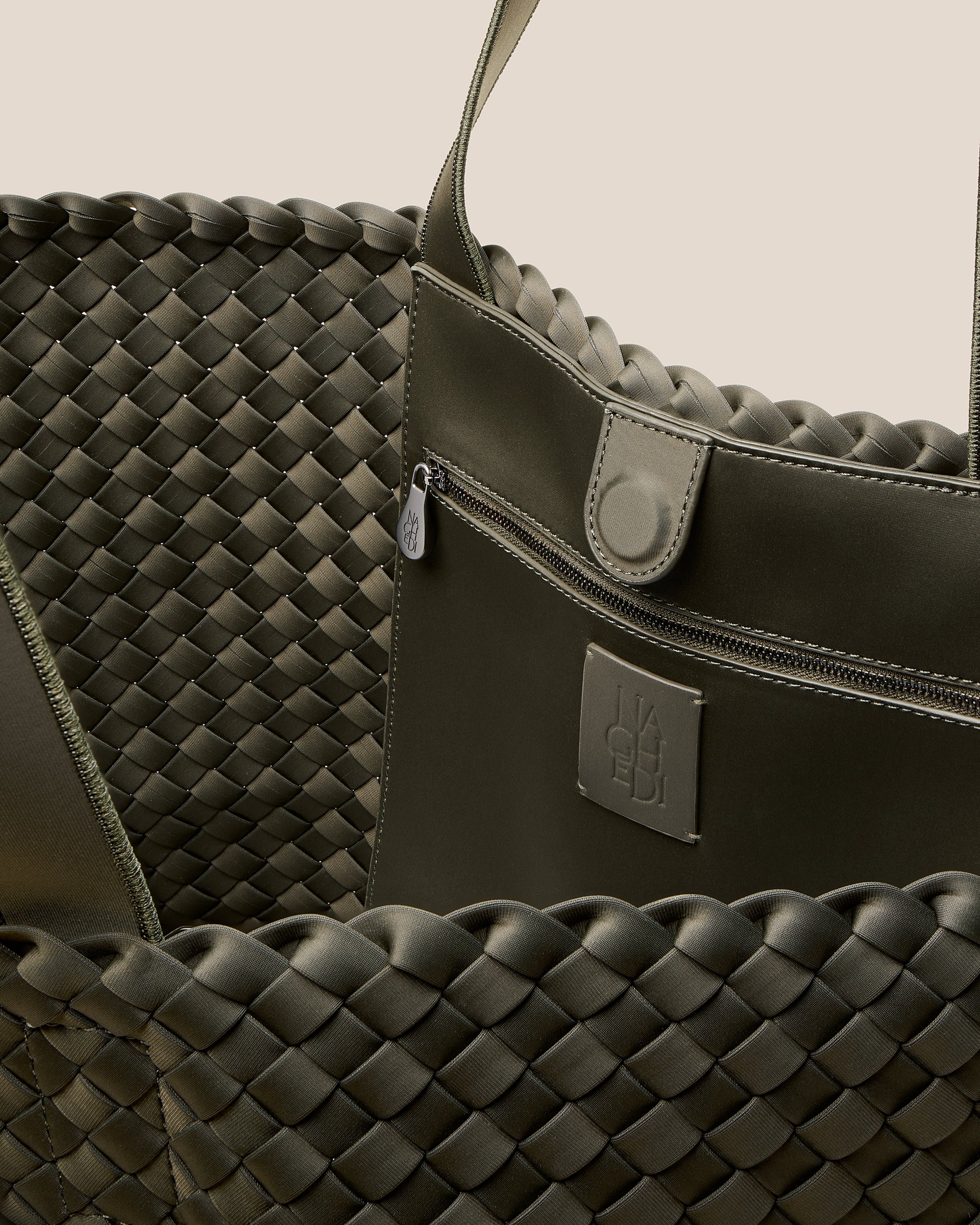 Interior close-up of Como Tote in Olive showing its open top with magnetic snap closure, interior zip pocket, and unlined interior.