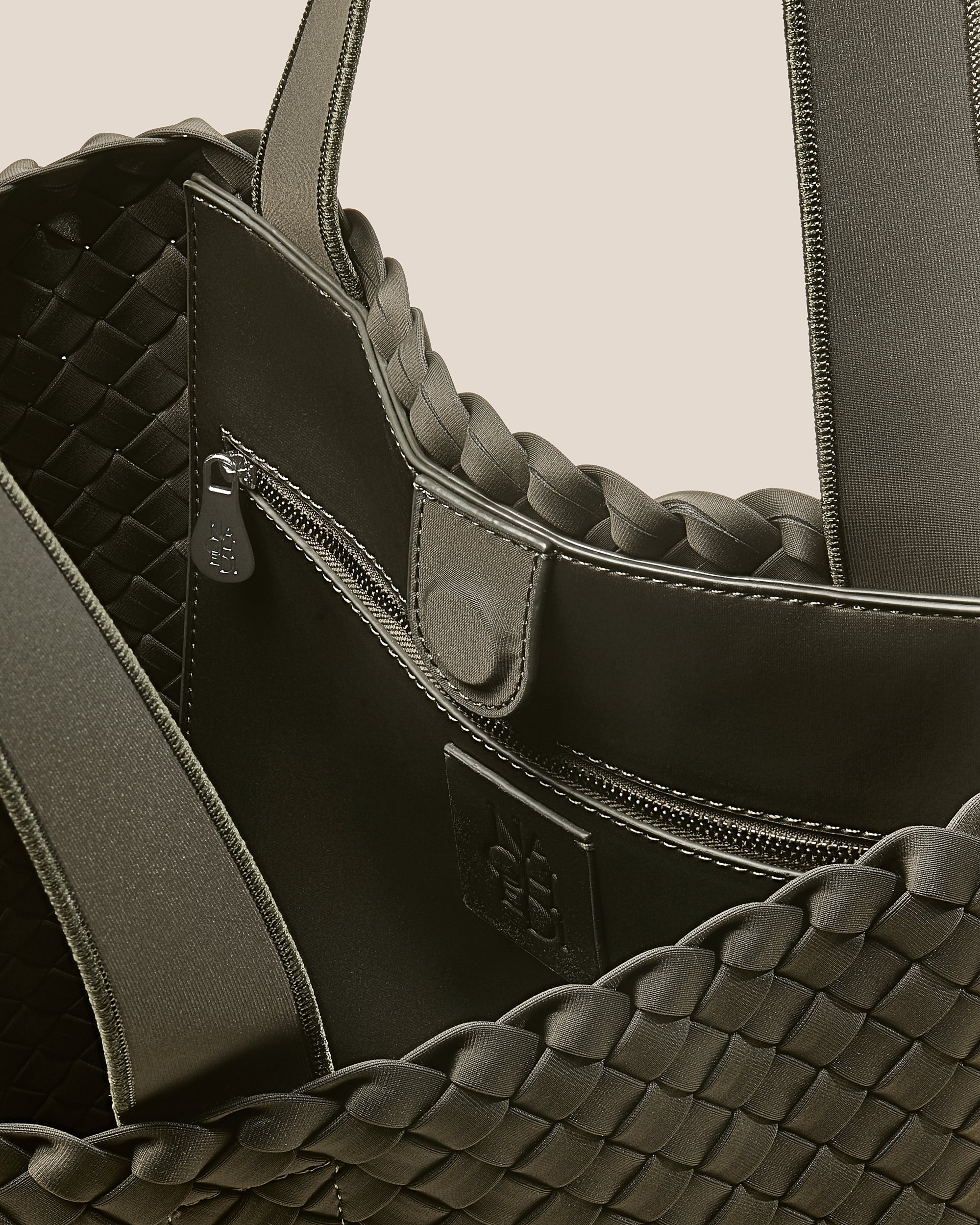 Interior close-up of Como Tote in Olive showing its open top with magnetic snap closure, interior zip pocket, and unlined interior.