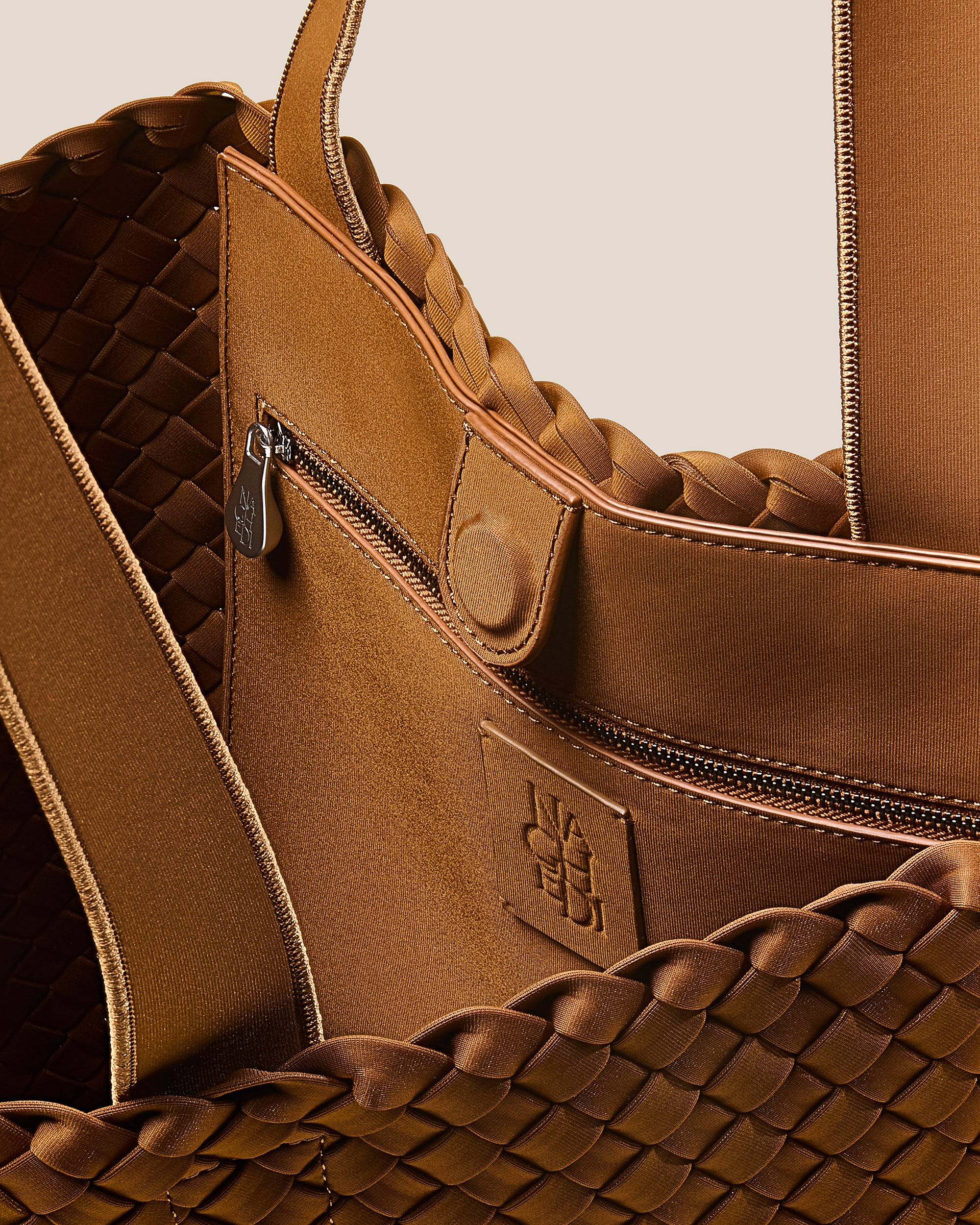 Interior close-up of Como Tote in Teak showing its open top with magnetic snap closure, interior zip pocket, and unlined interior.