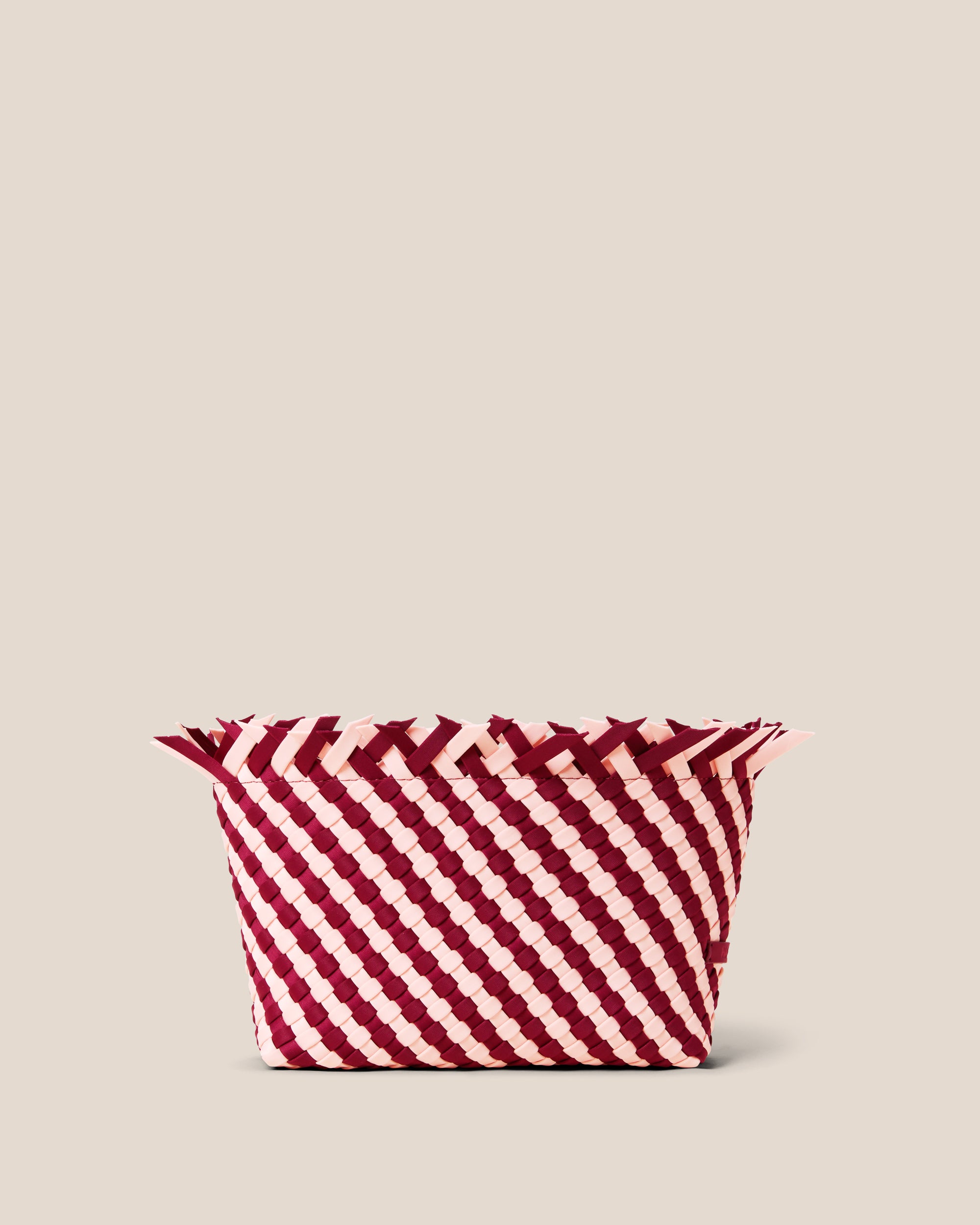 Havana  in Jaipur, a burgundy and peach tone, in handwoven neoprene, featuring a magnetic snap closure.