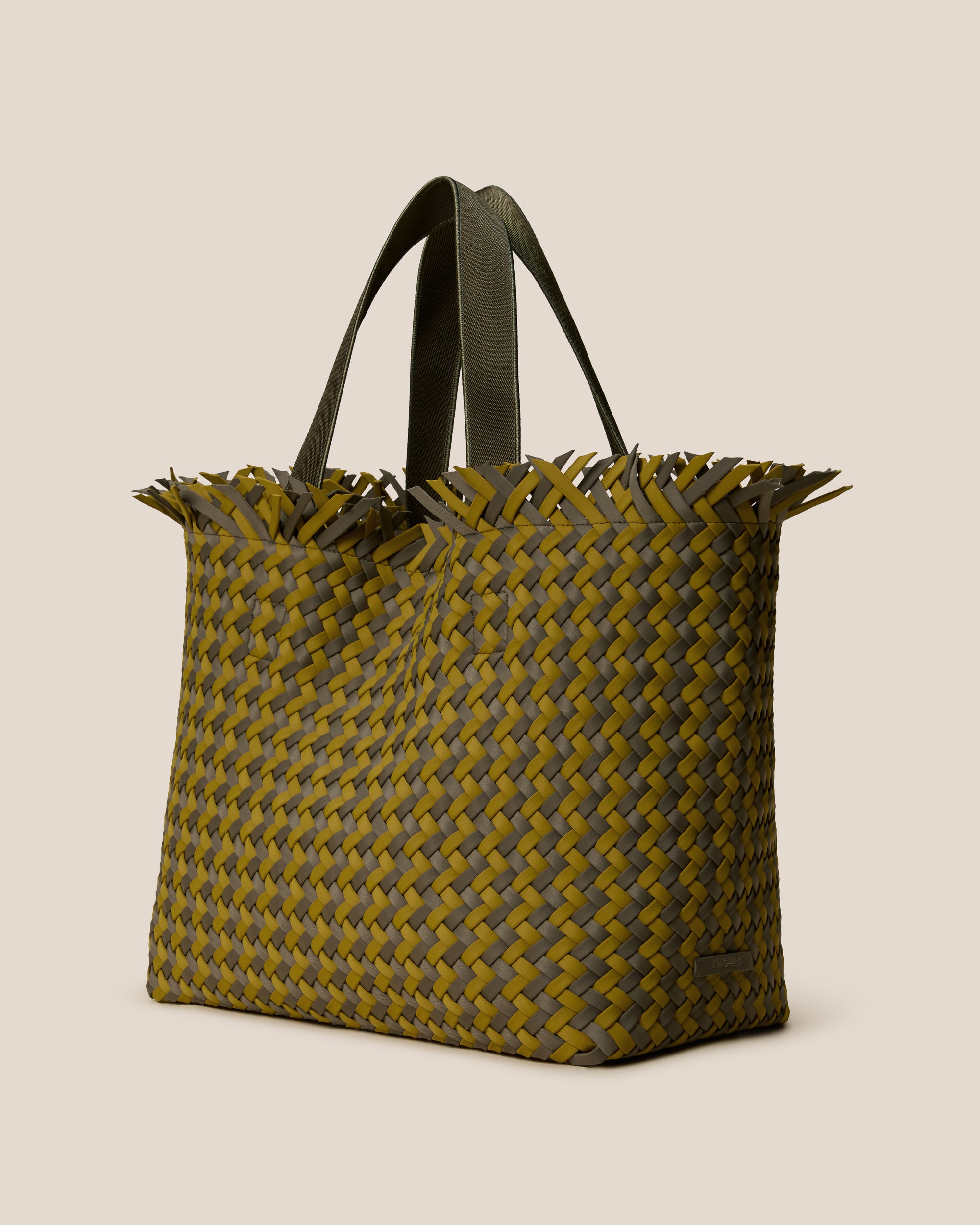 Havana  in Palma shown from a side angle, highlighting its handwoven neoprene construction and open top with magnetic snap closure.