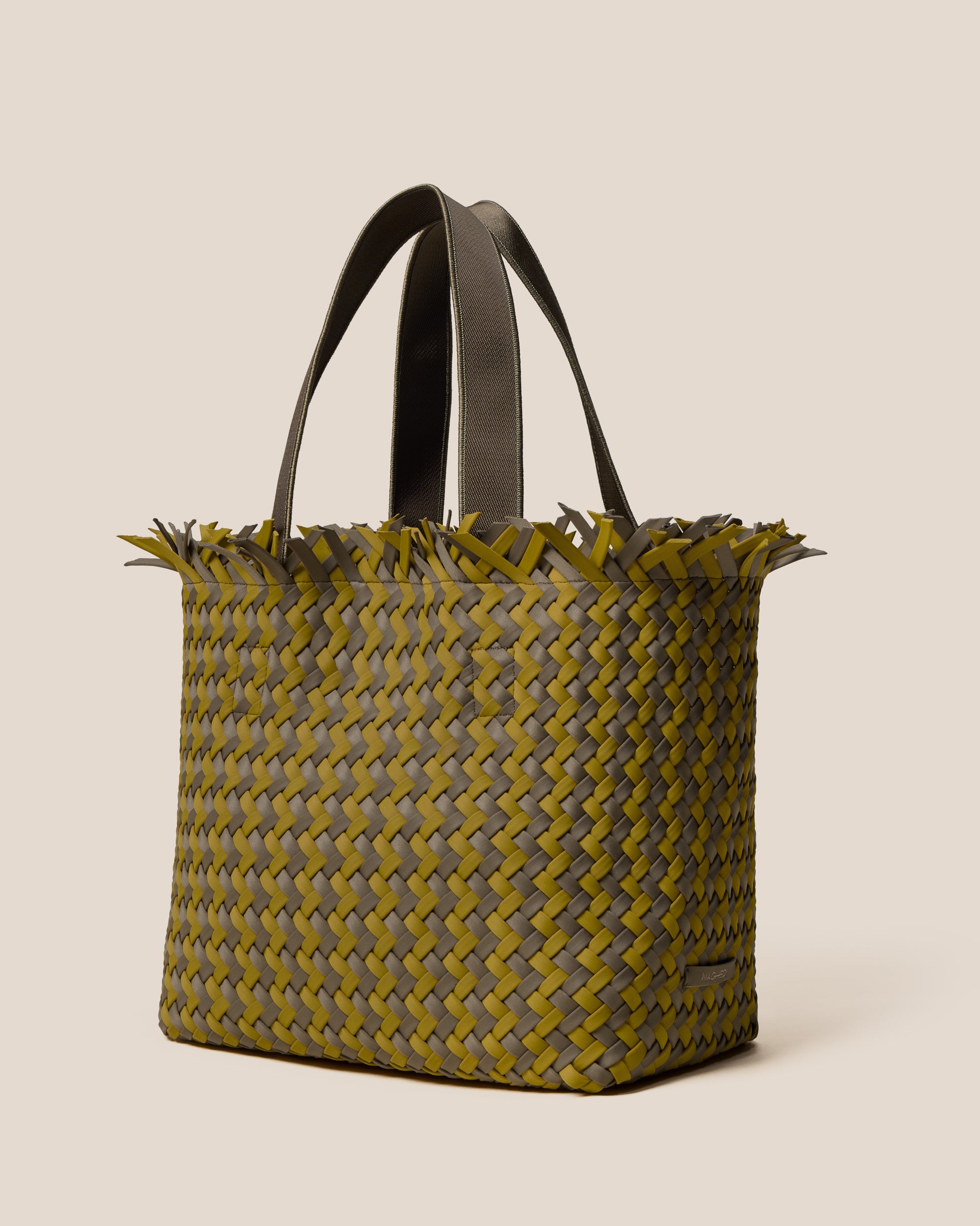 Havana  in Palma shown from a side angle, highlighting its handwoven neoprene construction and open top with magnetic snap closure.