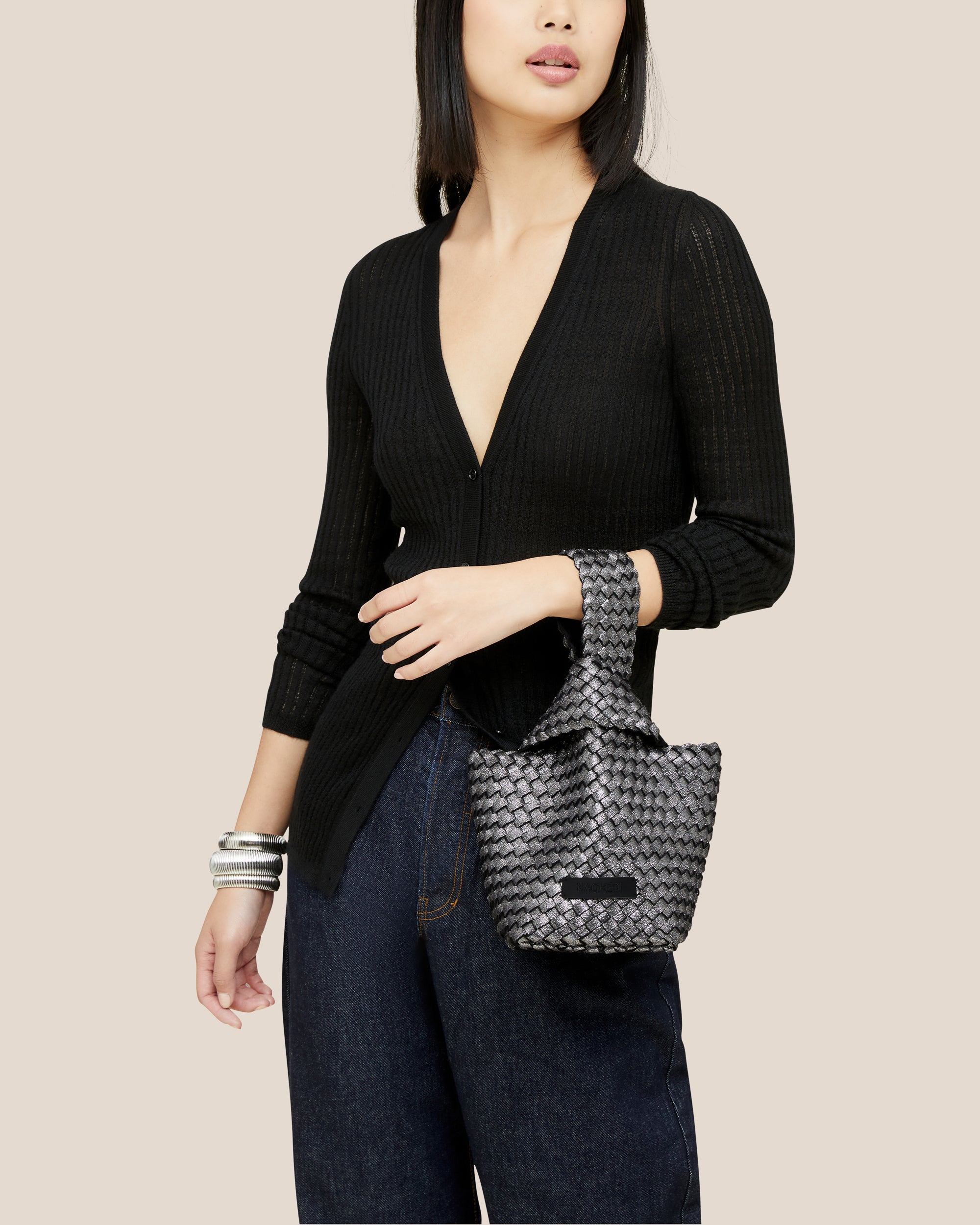 Kyoto Clutch in Titanium shown on model to illustrate scale and soft silhouette.