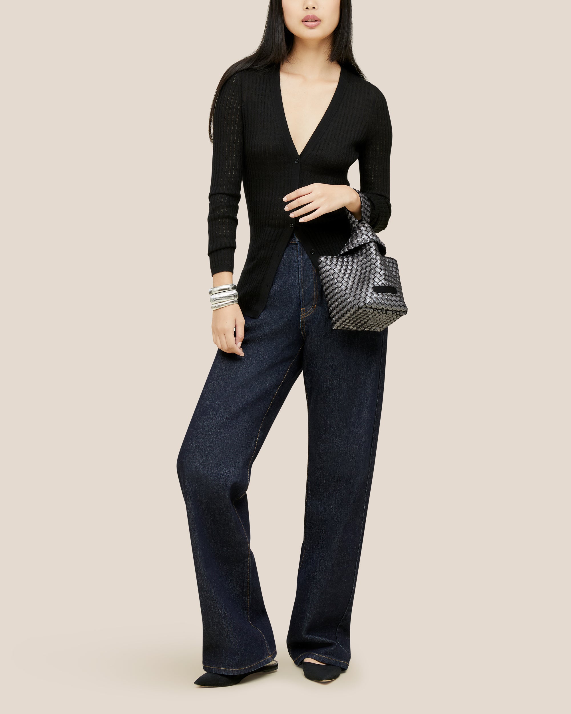 Kyoto Clutch in Titanium shown on model to illustrate scale and soft silhouette.