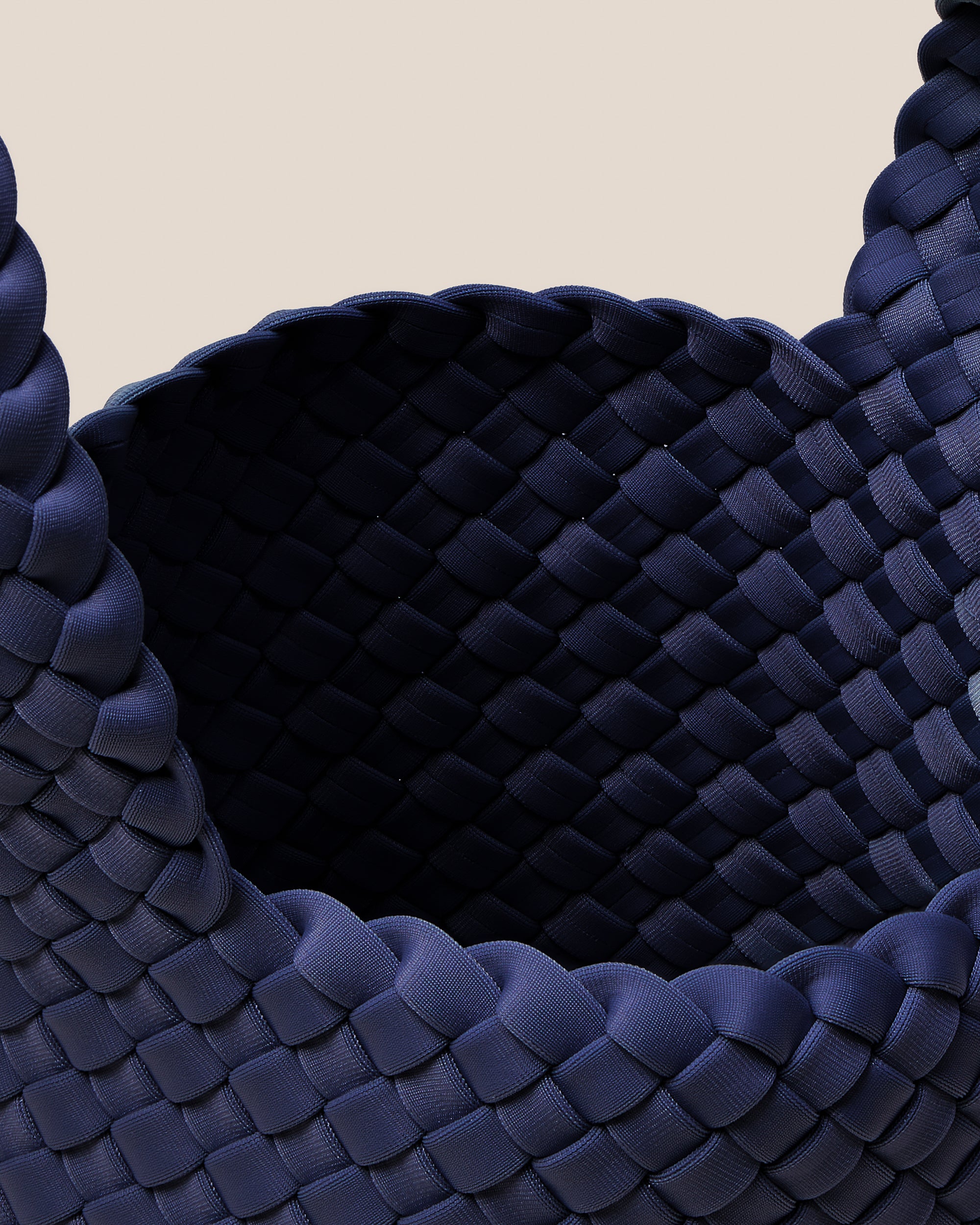 Interior close-up of Kyoto Clutch in Ink Blue showing its secure slide-through loop closure, and unlined interior.