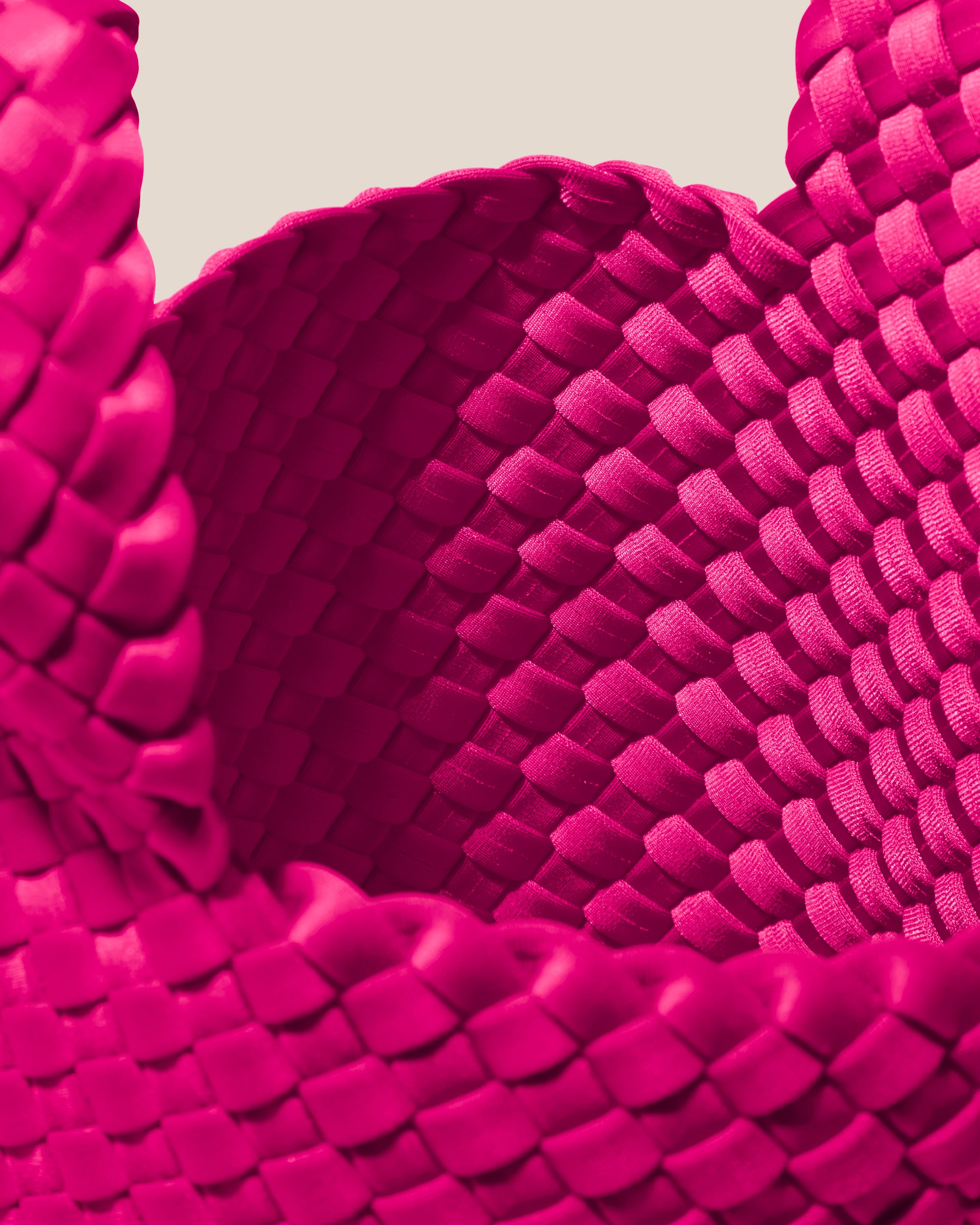 Interior close-up of Kyoto Clutch in Miami Pink showing its secure slide-through loop closure, and unlined interior.