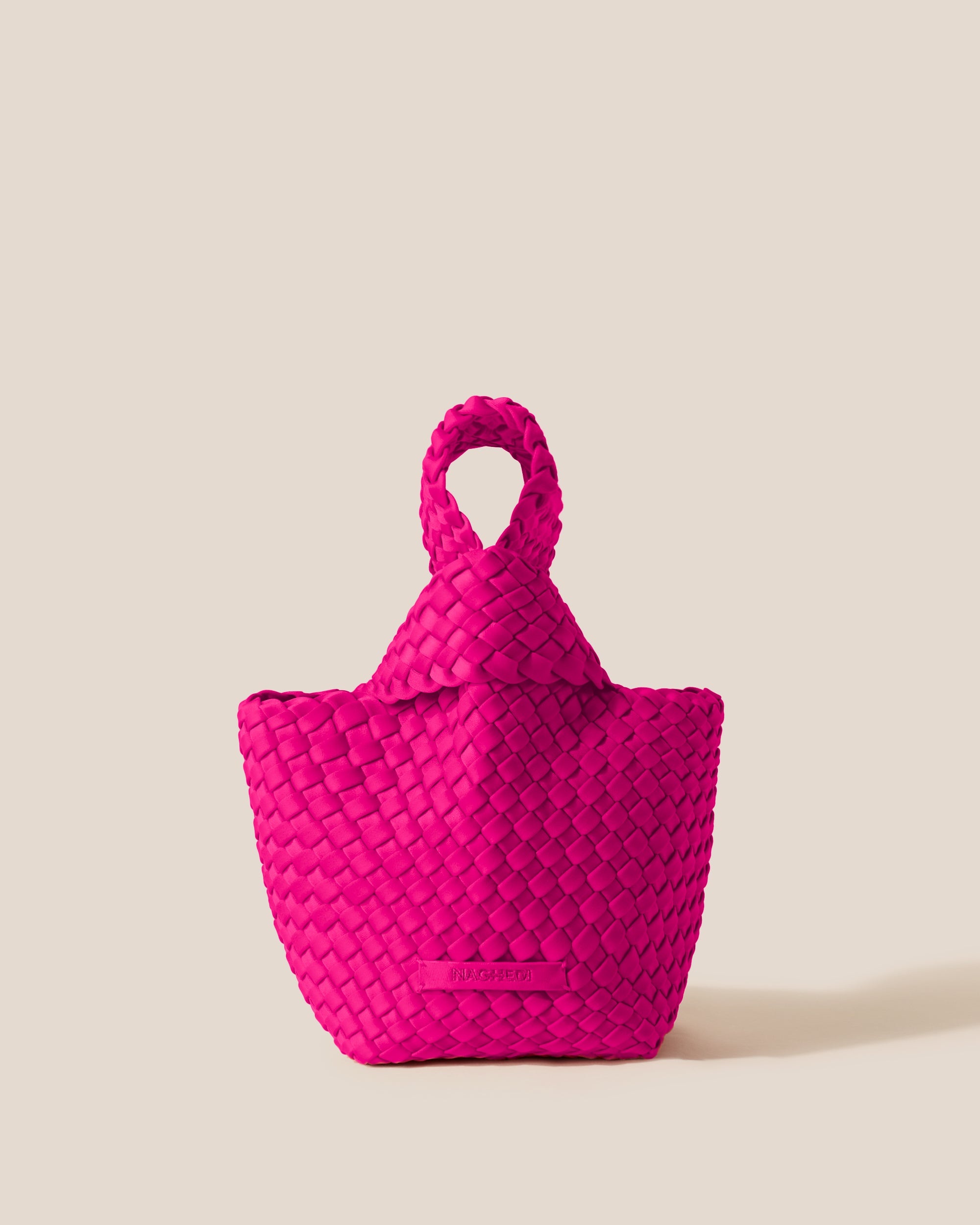 Kyoto Clutch in Miami Pink, a vibrant pink tone, in handwoven neoprene, featuring a secure slide-through loop closure.