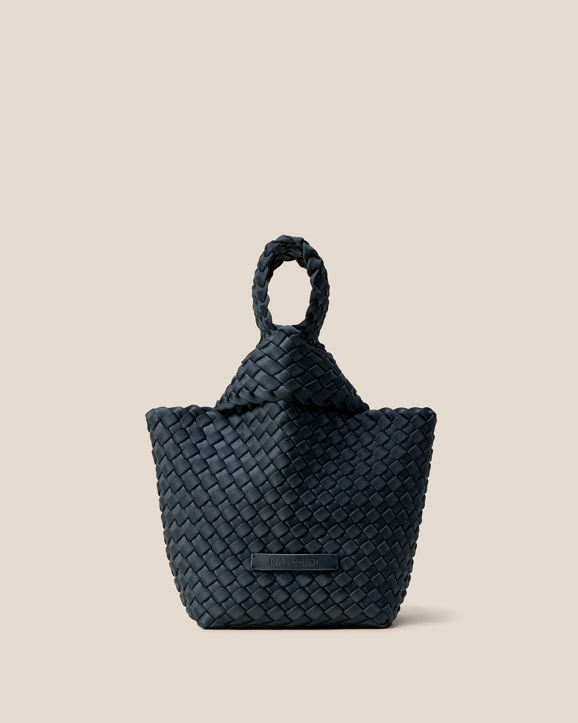 Kyoto Clutch in Murano, a midnight teal blue tone, in handwoven neoprene, featuring a secure slide-through loop closure.