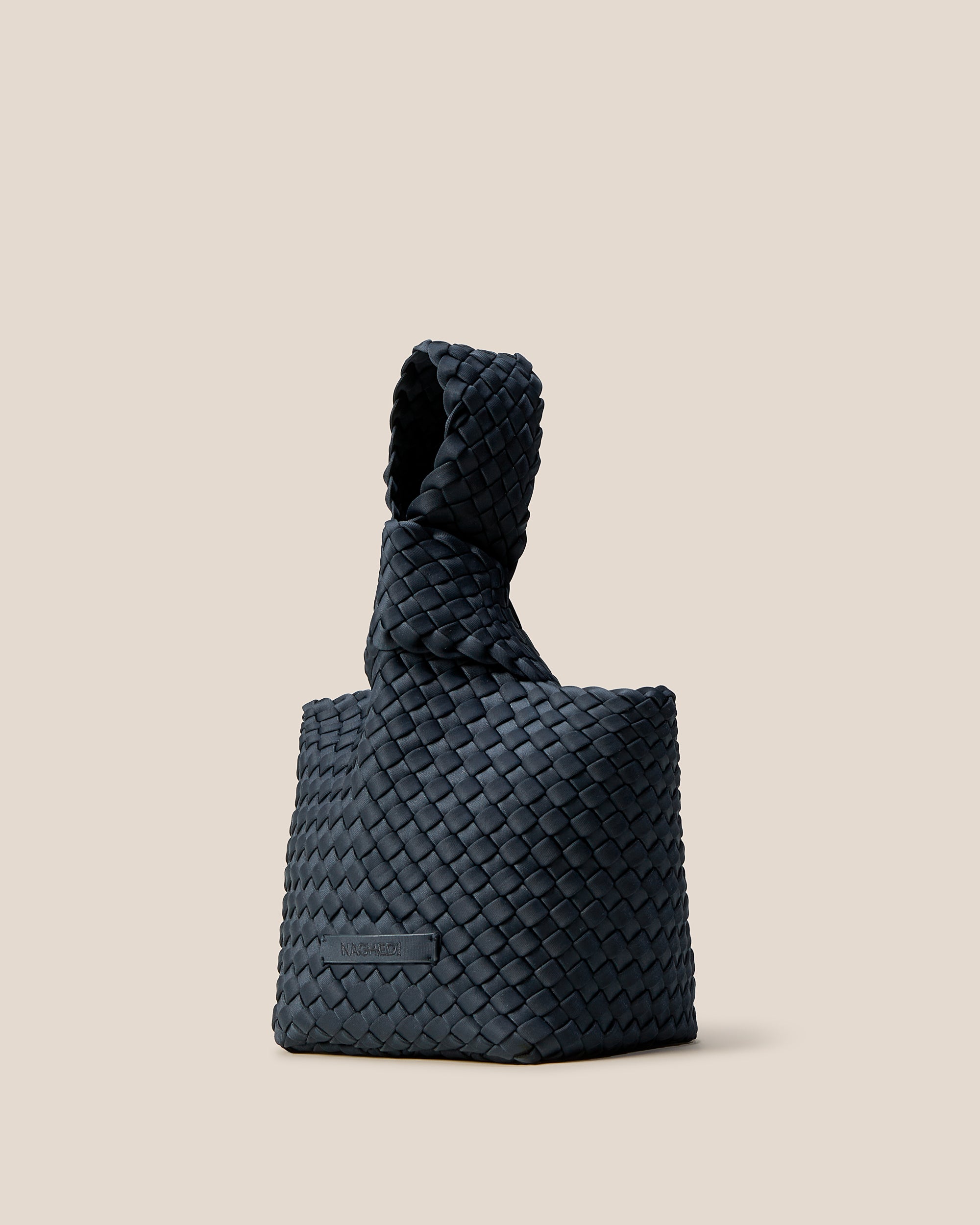 Kyoto Clutch in Murano shown from a side angle, highlighting its handwoven neoprene construction and secure slide-through loop closure.
