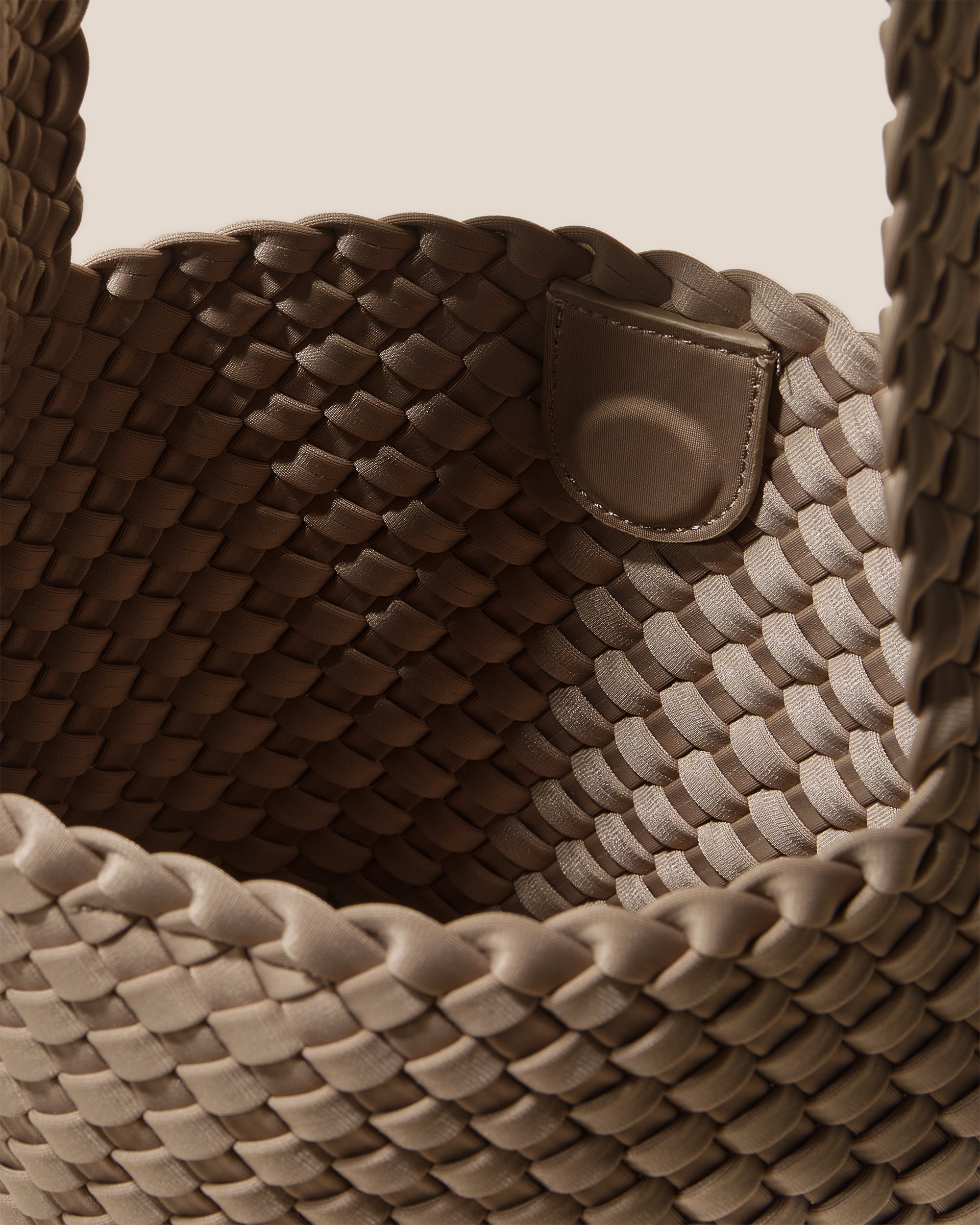 Interior close-up of Laguna Crossbody in Cashmere showing its open top with magnetic snap closure, and unlined interior.