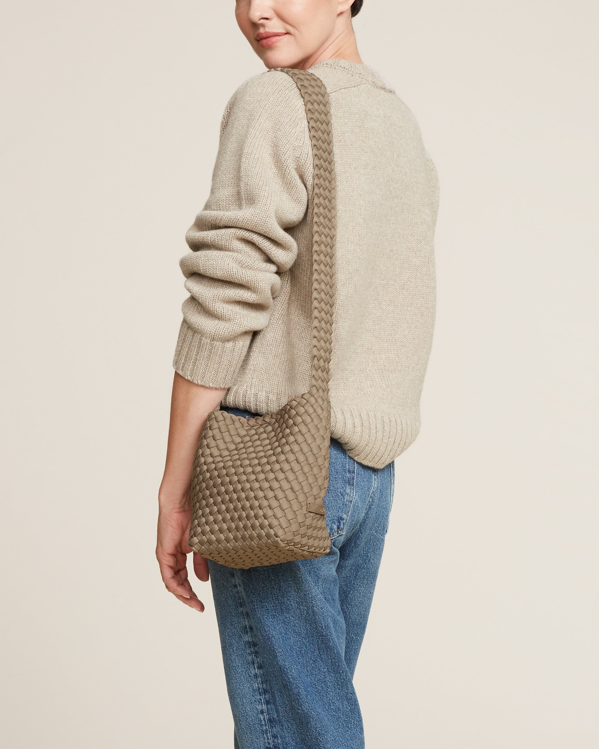 Laguna Crossbody in Cashmere shown on model to illustrate scale and soft silhouette.