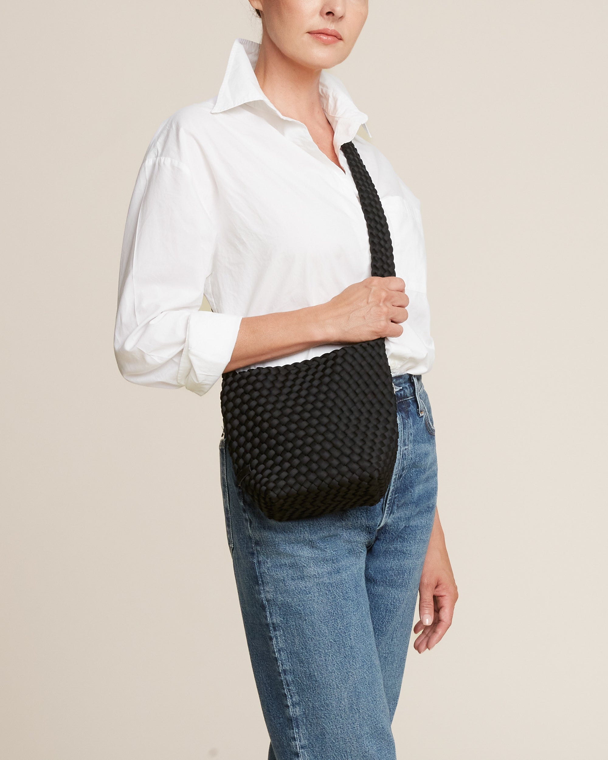 Laguna Crossbody in Onyx shown on model to illustrate scale and soft silhouette.