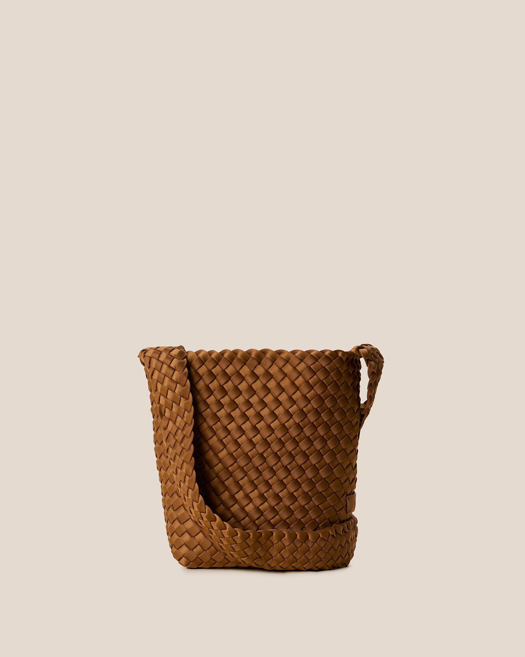 Laguna Crossbody in Teak, a saddle brown tone, in handwoven neoprene, featuring an open top with magnetic snap closure, and handwoven crossbody strap lays comfortably flat.