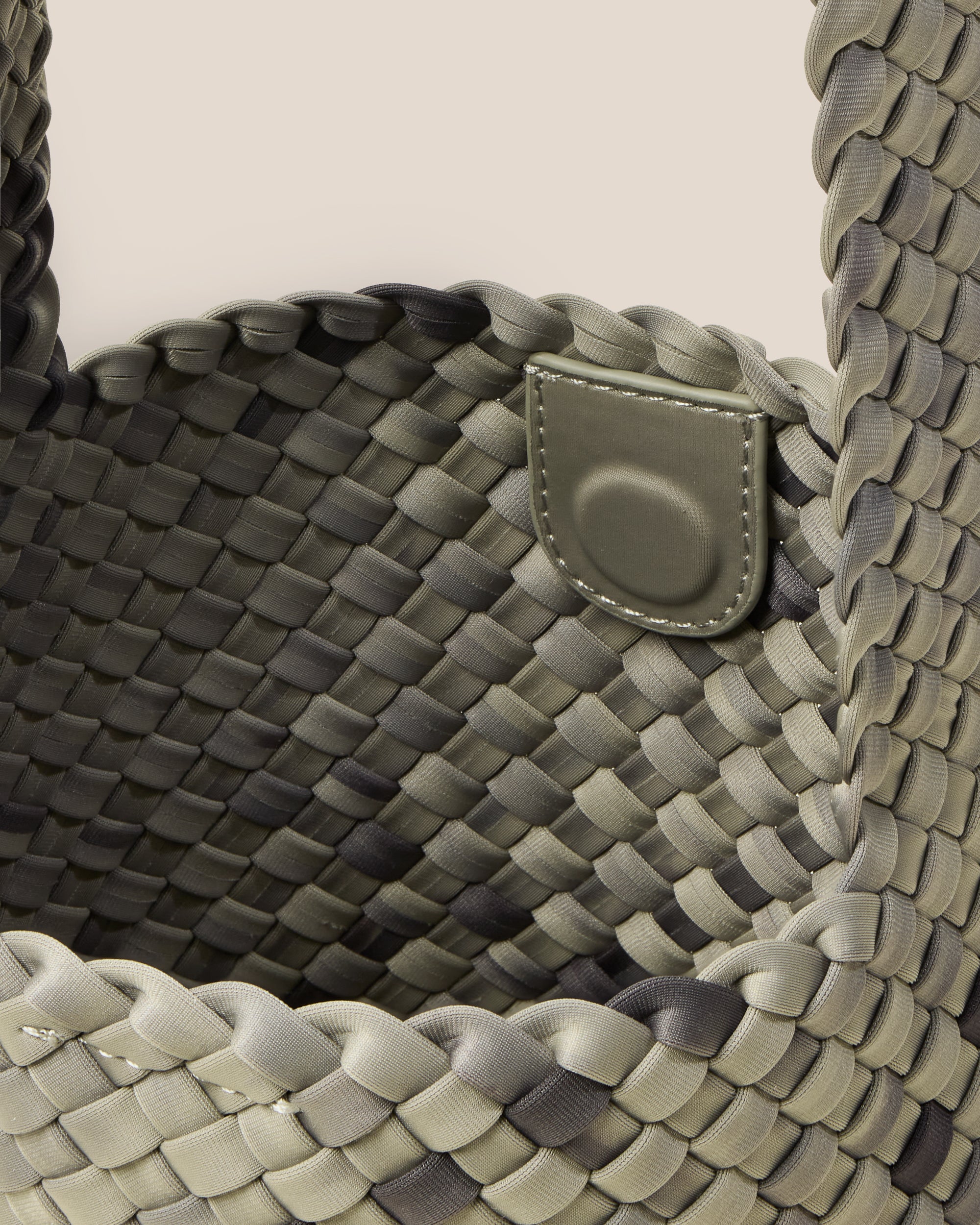 Interior close-up of Laguna Crossbody in Neptune showing its open top with magnetic snap closure, and unlined interior.