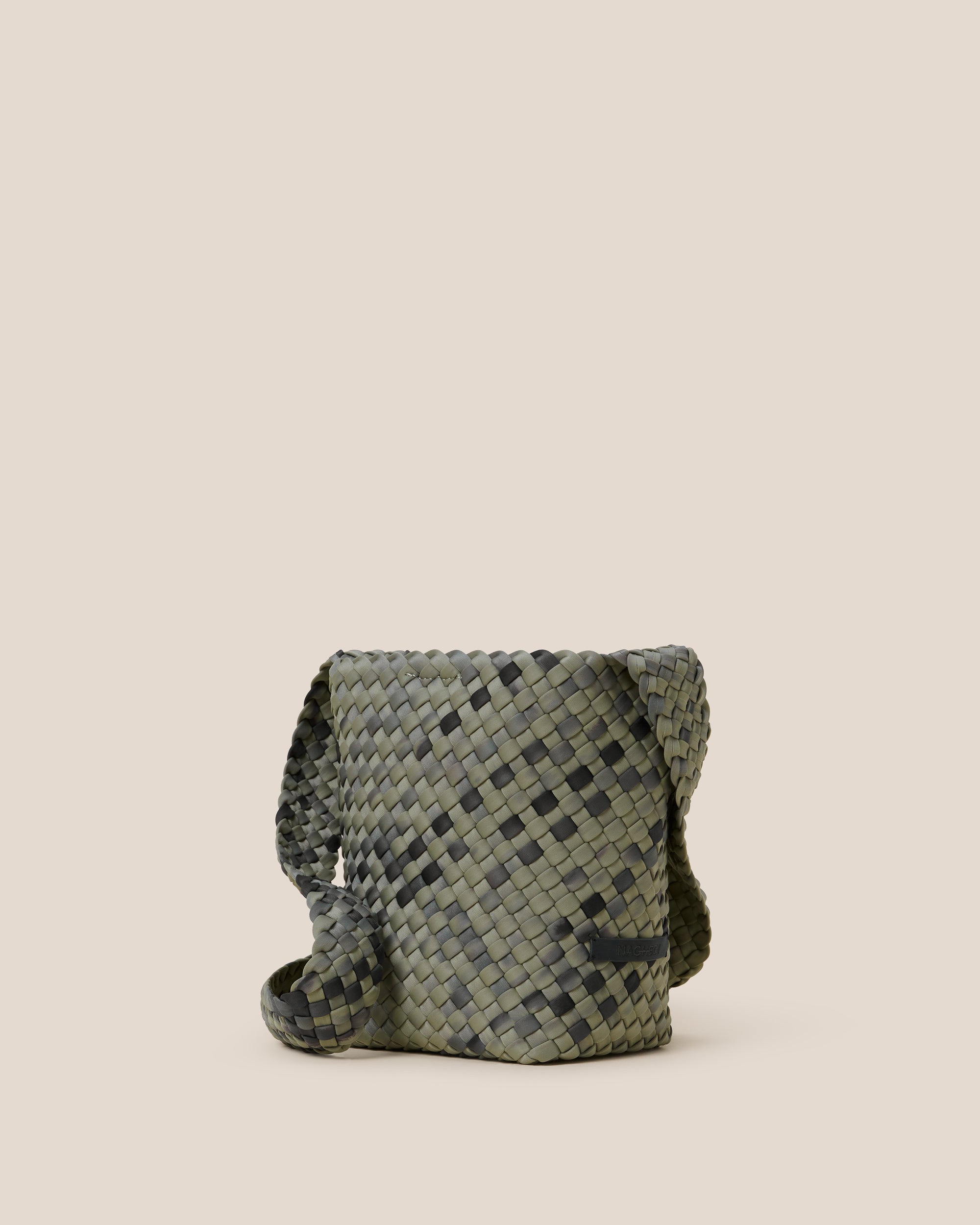 Laguna Crossbody in Neptune shown from a side angle, highlighting its handwoven neoprene construction and open top with magnetic snap closure.