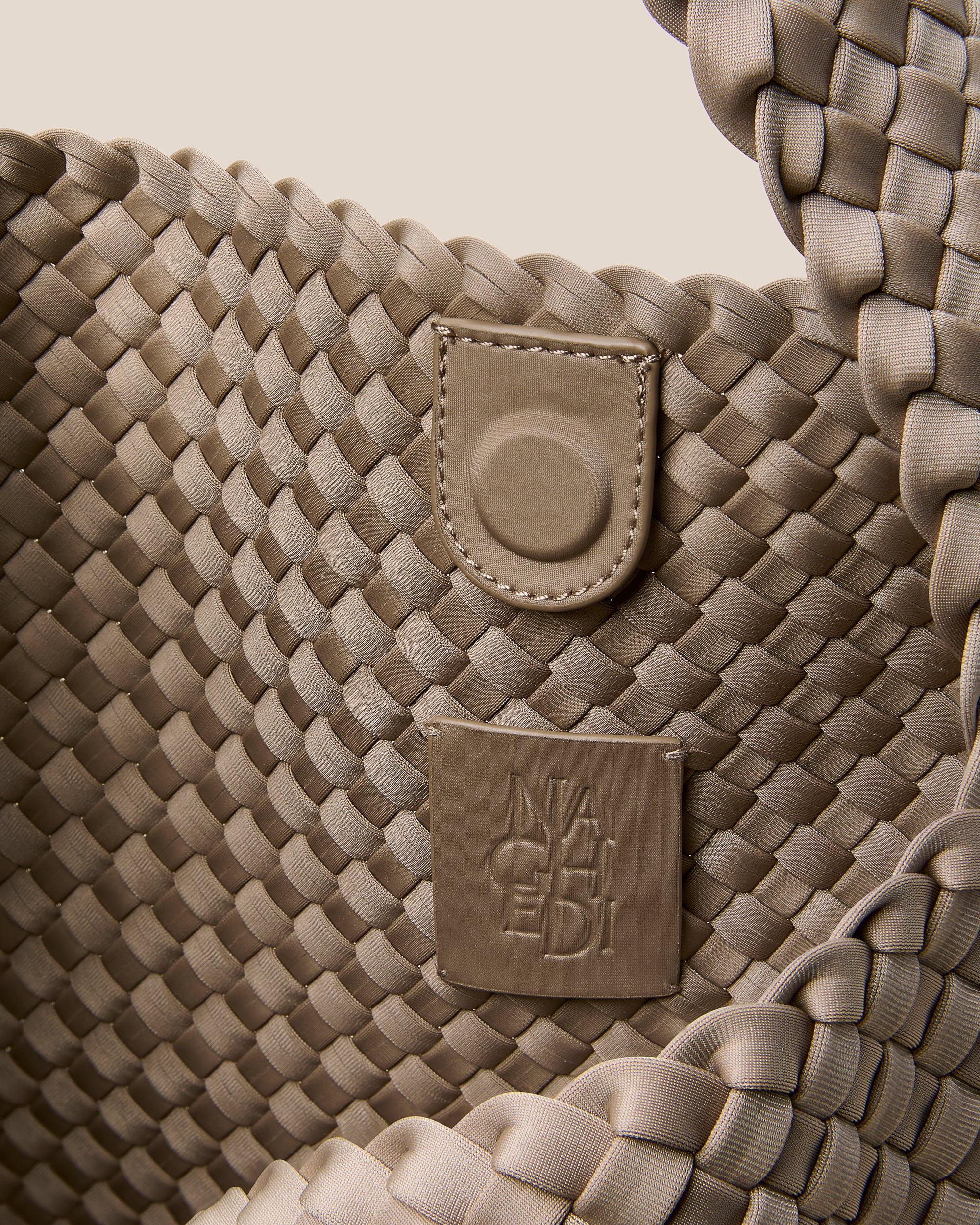 Interior close-up of Nomad Hobo in Cashmere showing its open top with magnetic snap closure, and unlined interior.