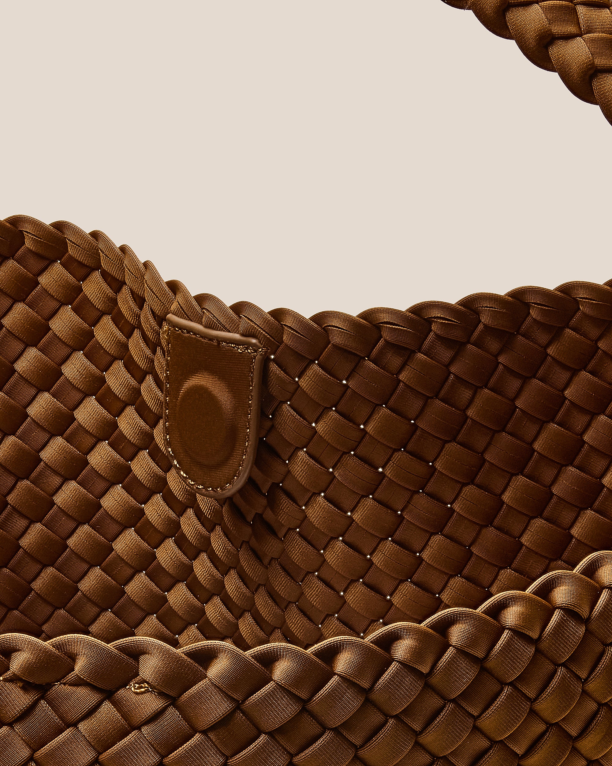 Interior close-up of Nomad Hobo in Teak showing its open top with magnetic snap closure, and unlined interior.