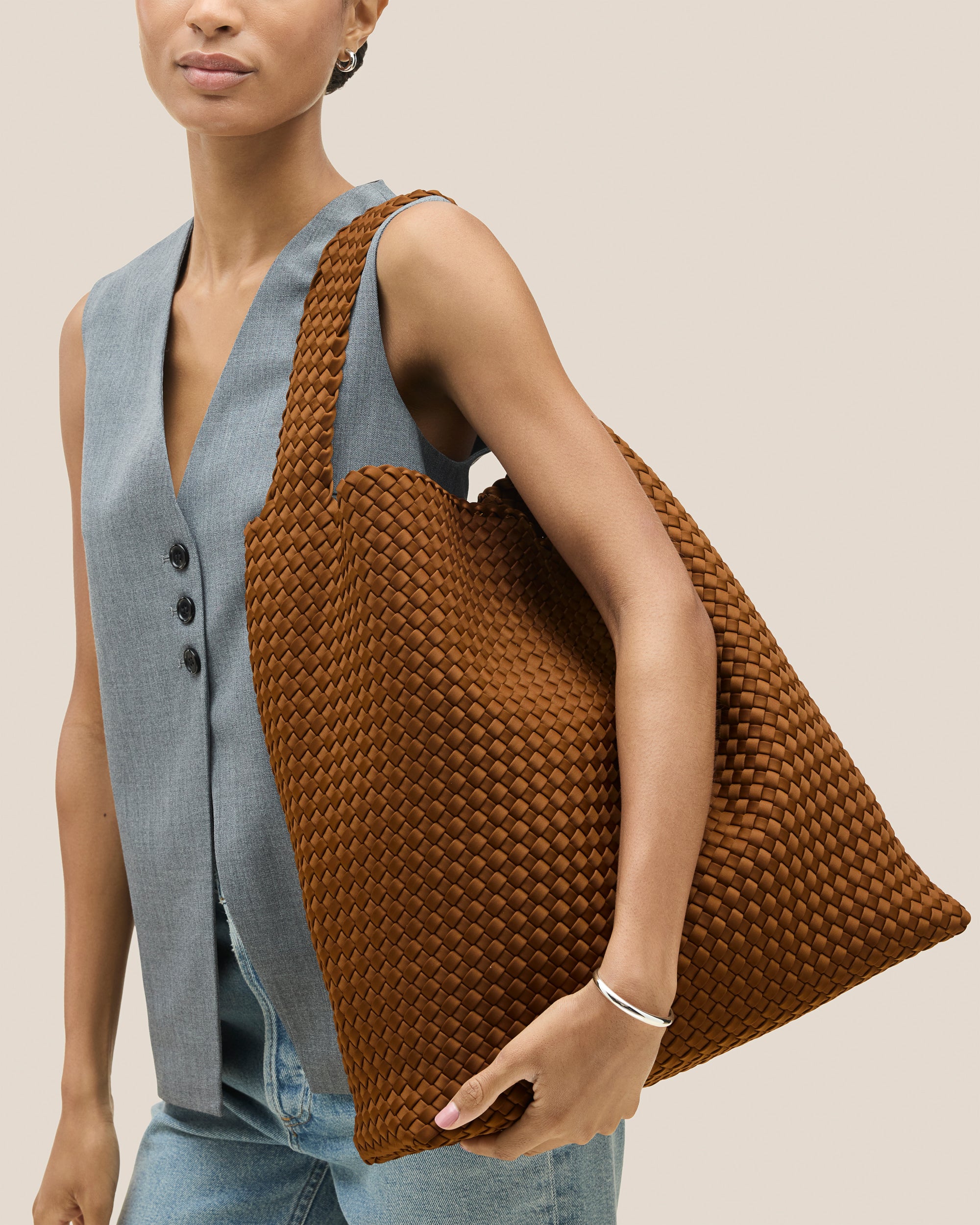 Nomad Hobo in Teak shown on model to illustrate scale and soft silhouette.