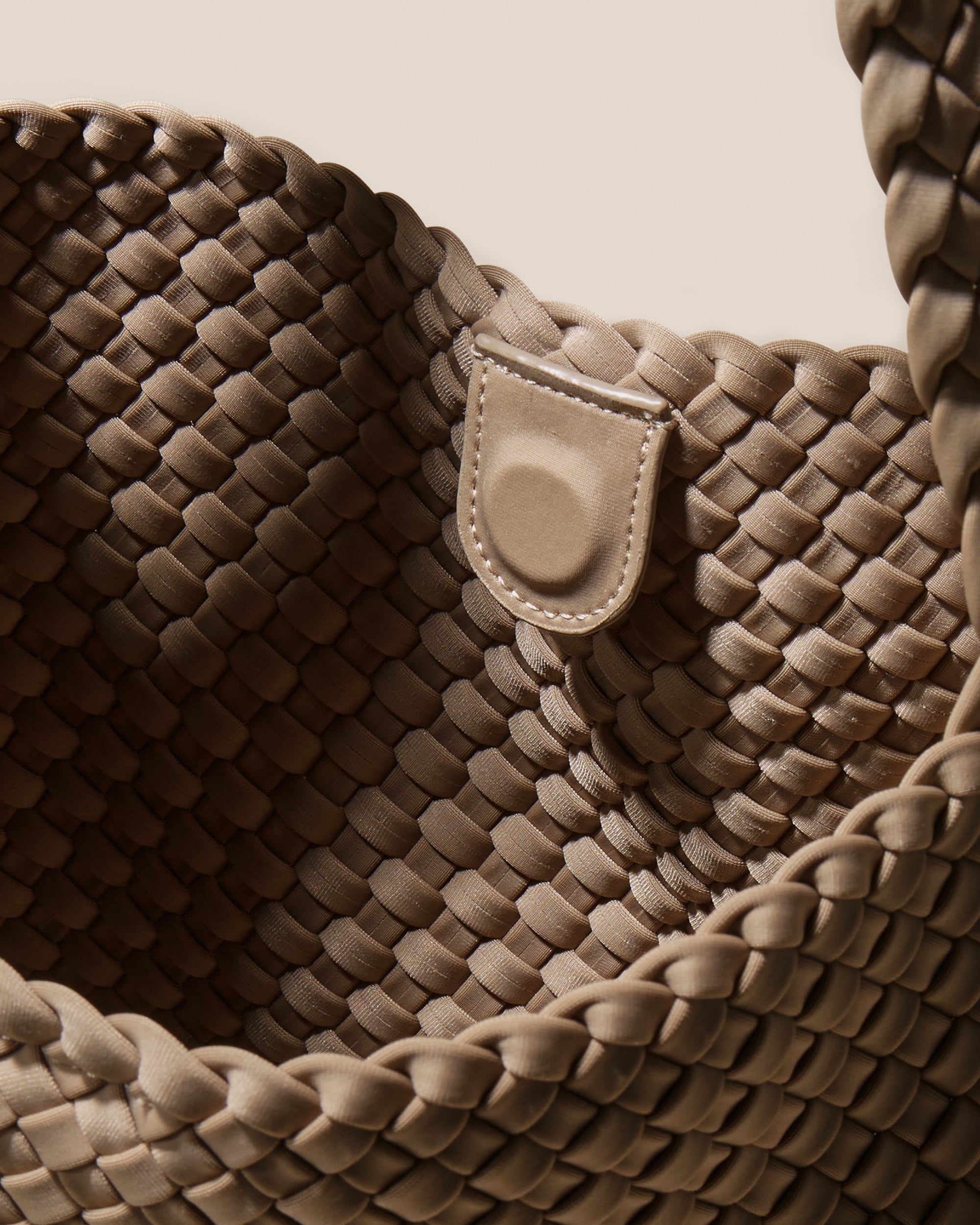 Interior close-up of Nomad Hobo in Cashmere showing its open top with magnetic snap closure, and unlined interior.