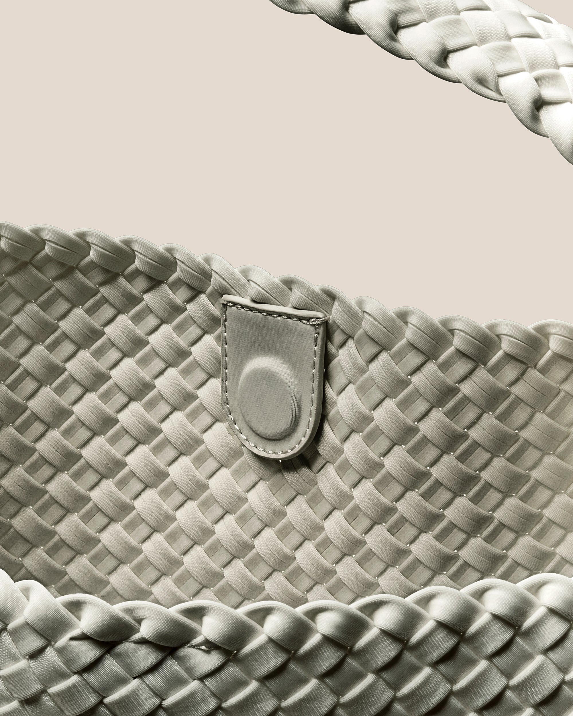 Interior close-up of Nomad Hobo in Celadon showing its open top with magnetic snap closure, and unlined interior.