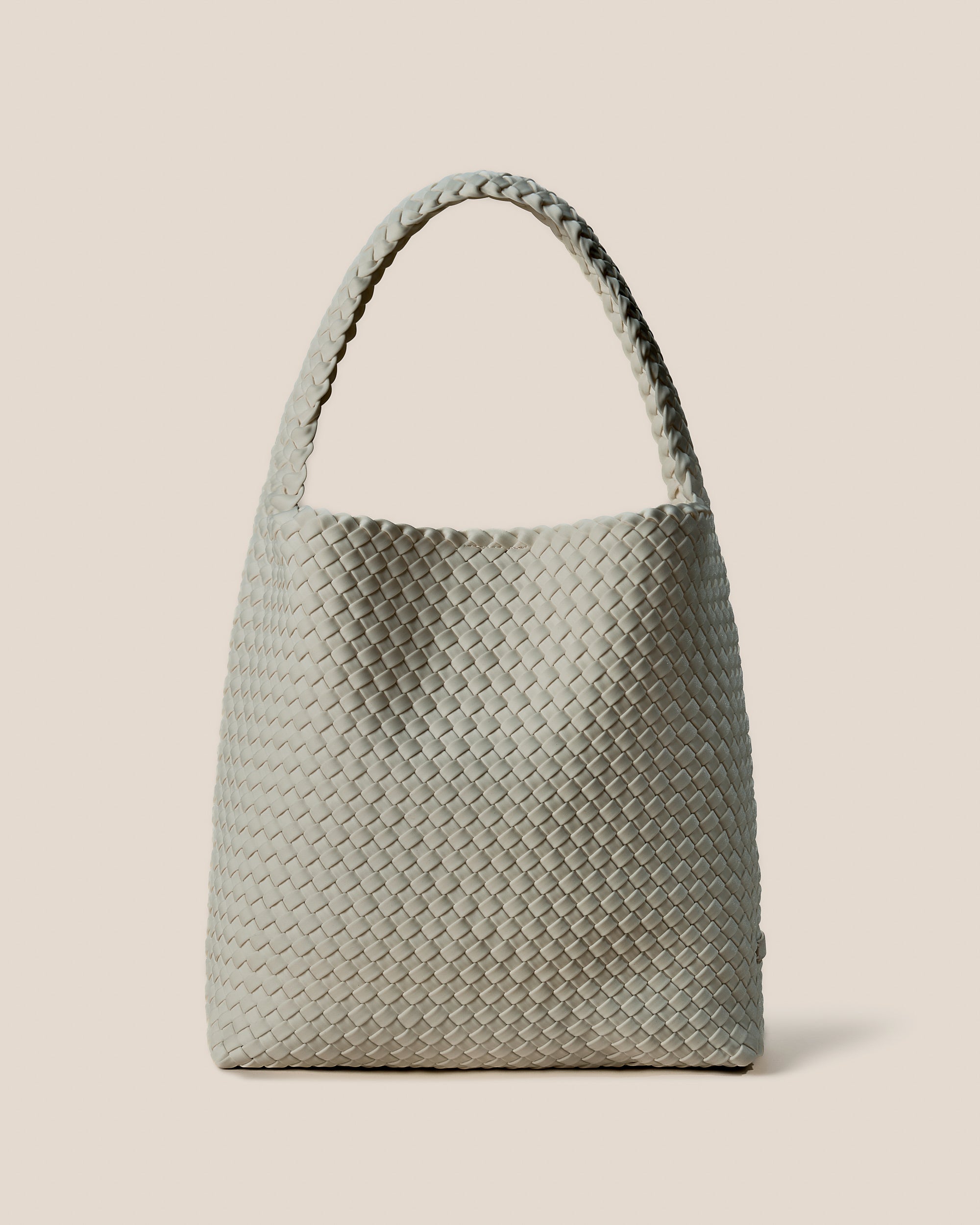 Nomad Hobo in Celadon, a light jade green tone, in handwoven neoprene, featuring an open top with magnetic snap closure, and handwoven shoulder strap lays comfortably flat.