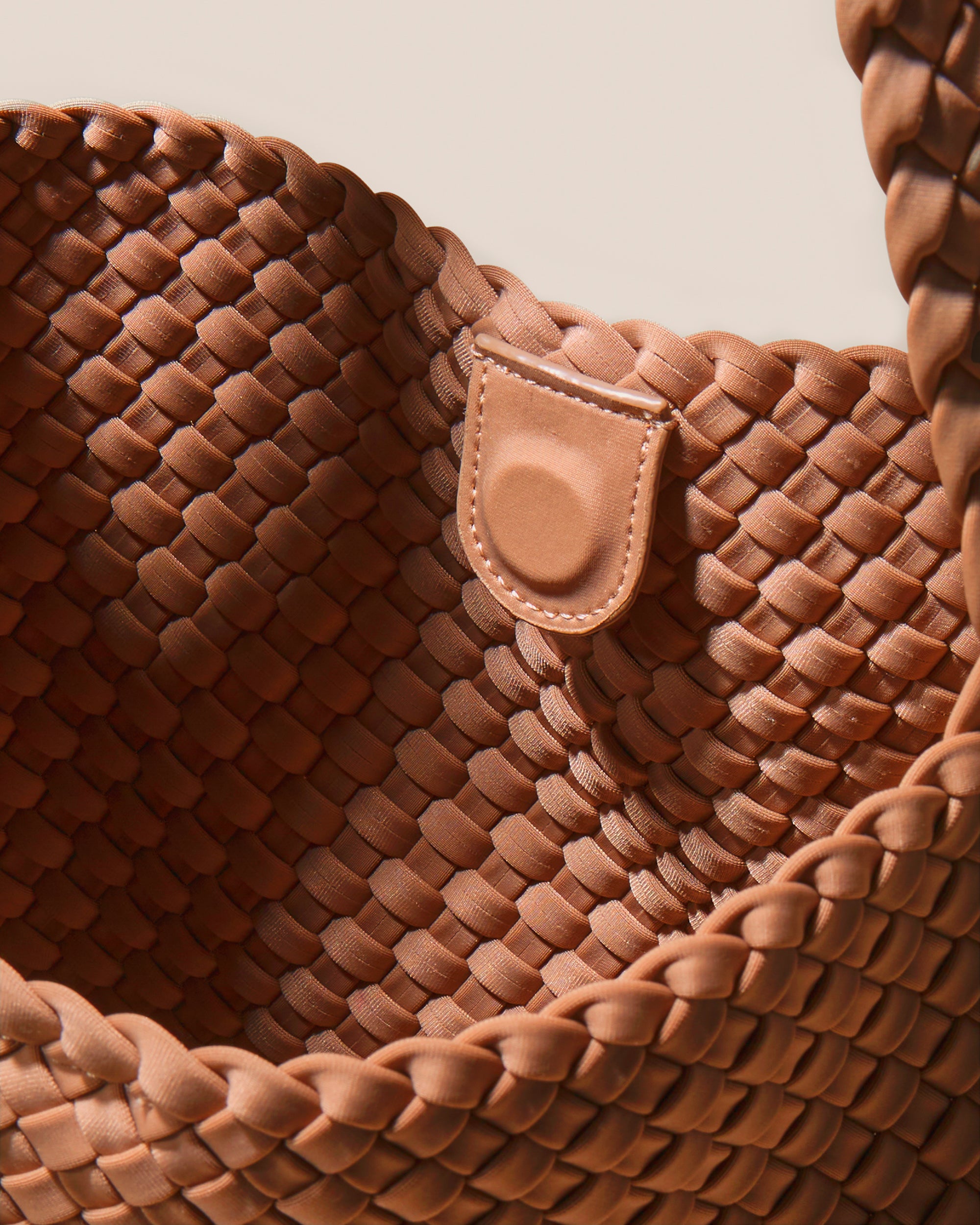 Interior close-up of Nomad Hobo in Cocoa showing its open top with magnetic snap closure, and unlined interior.