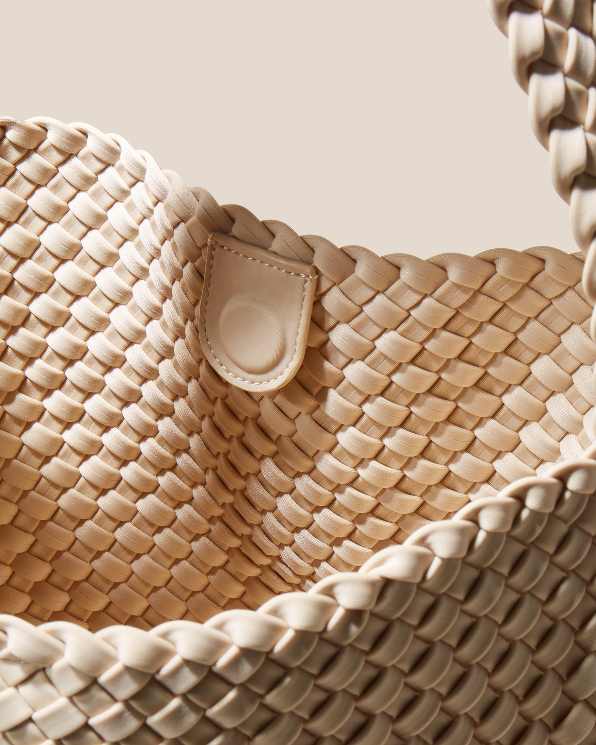 Interior close-up of Nomad Hobo in Ecru showing its open top with magnetic snap closure, and unlined interior.