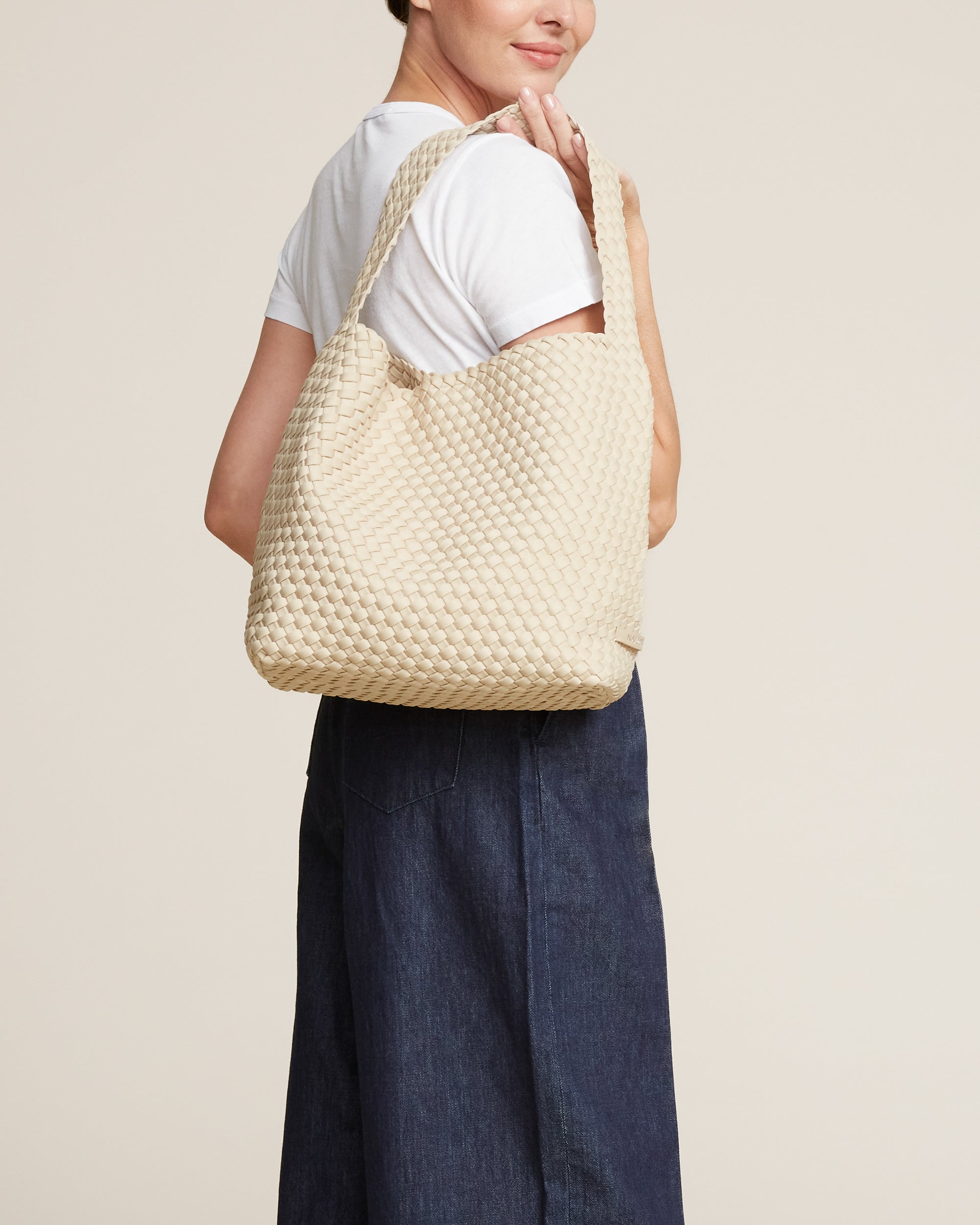 Nomad Hobo in Ecru shown on model to illustrate scale and soft silhouette.