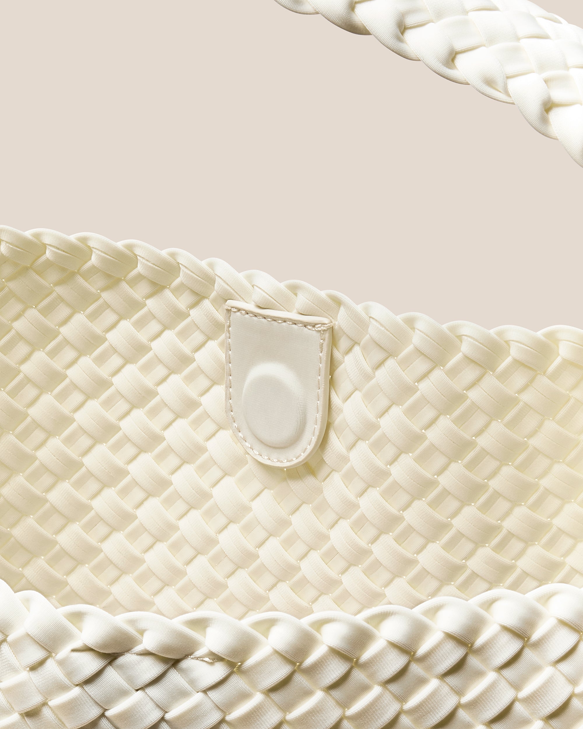 Interior close-up of Nomad Hobo in Jasmine showing its open top with magnetic snap closure, and unlined interior.