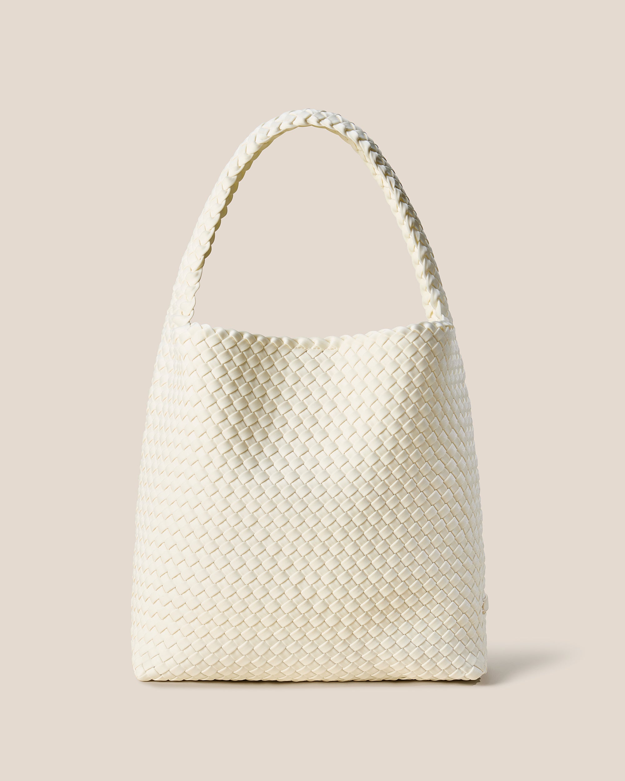 Nomad Hobo in Jasmine, an ivory tone, in handwoven neoprene, featuring an open top with magnetic snap closure, and handwoven shoulder strap lays comfortably flat.