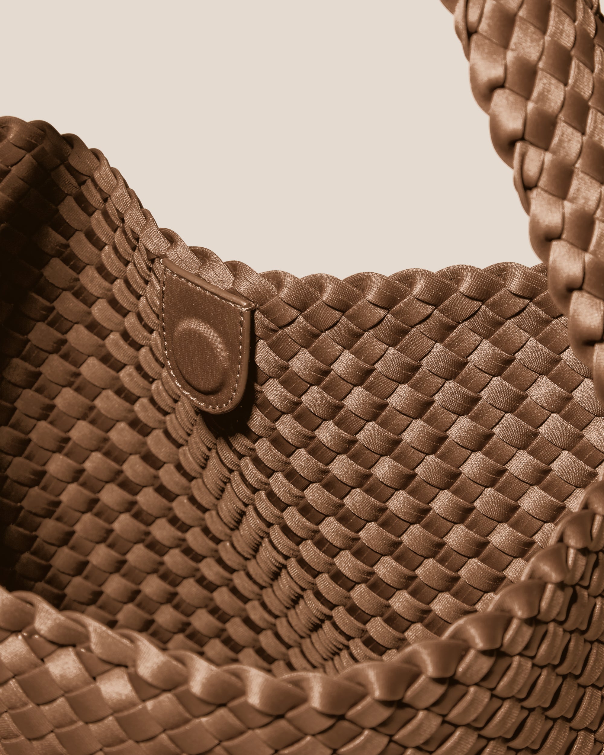 Interior close-up of Nomad Hobo in Mink showing its open top with magnetic snap closure, and unlined interior.