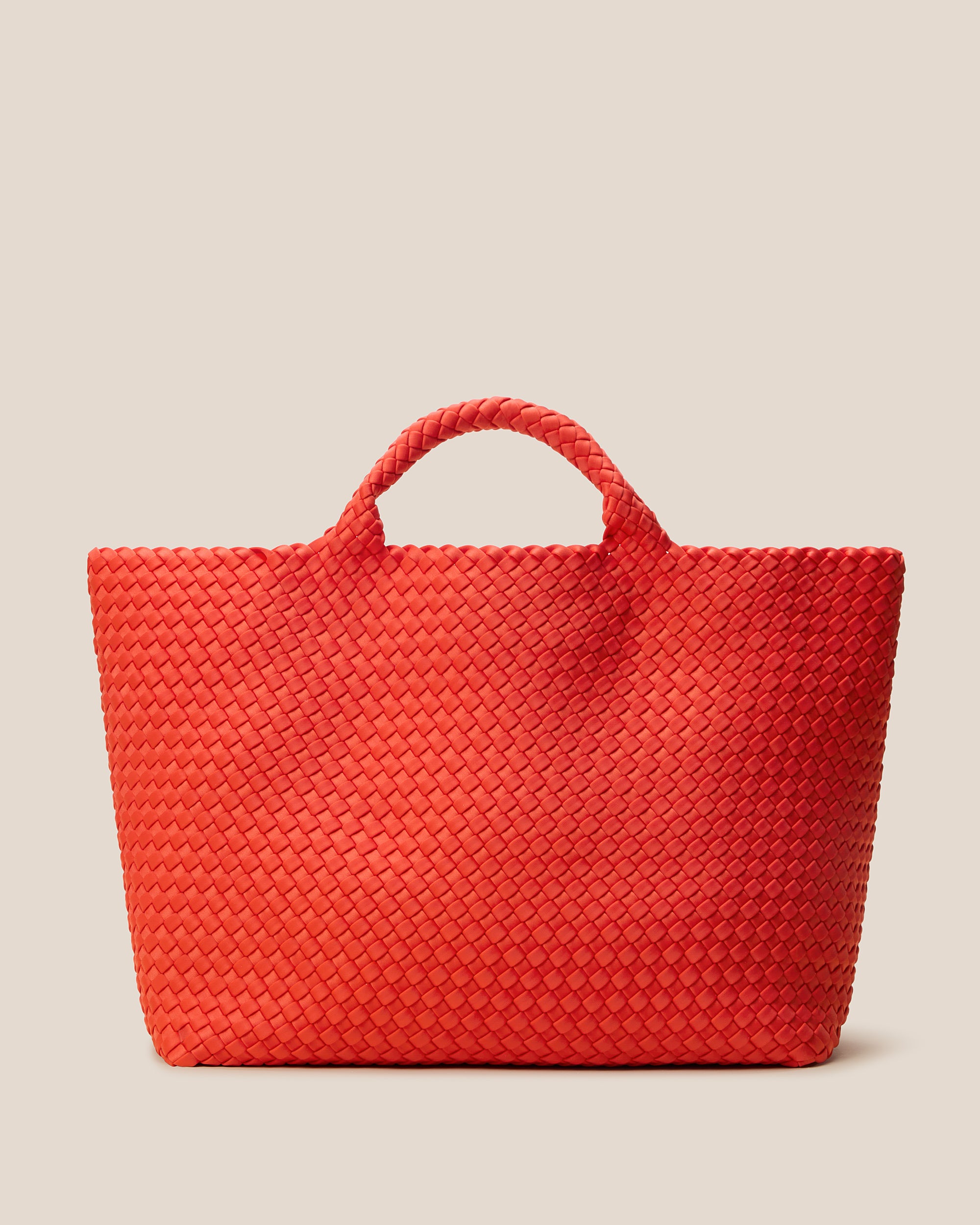 St. Barths Tote in Ipanema, a vibrant orange tone, in handwoven neoprene, featuring an open top, and woven top handles.