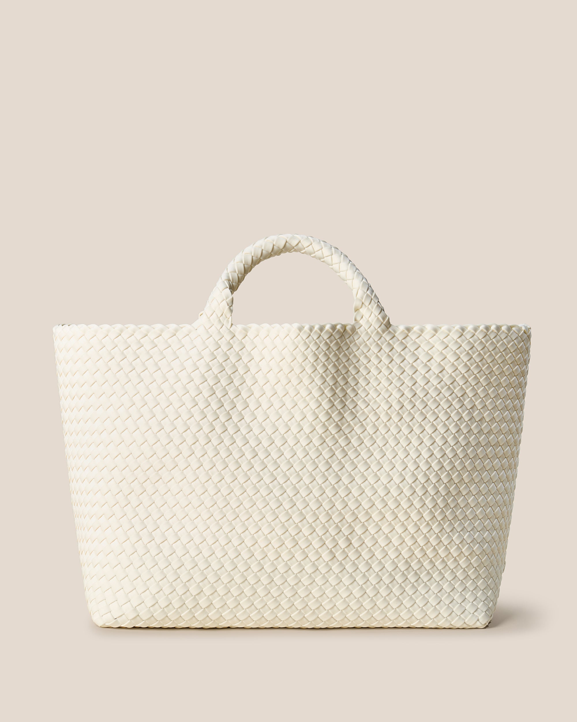 St. Barths Tote in Jasmine, an ivory tone, in handwoven neoprene, featuring an open top, and woven top handles.