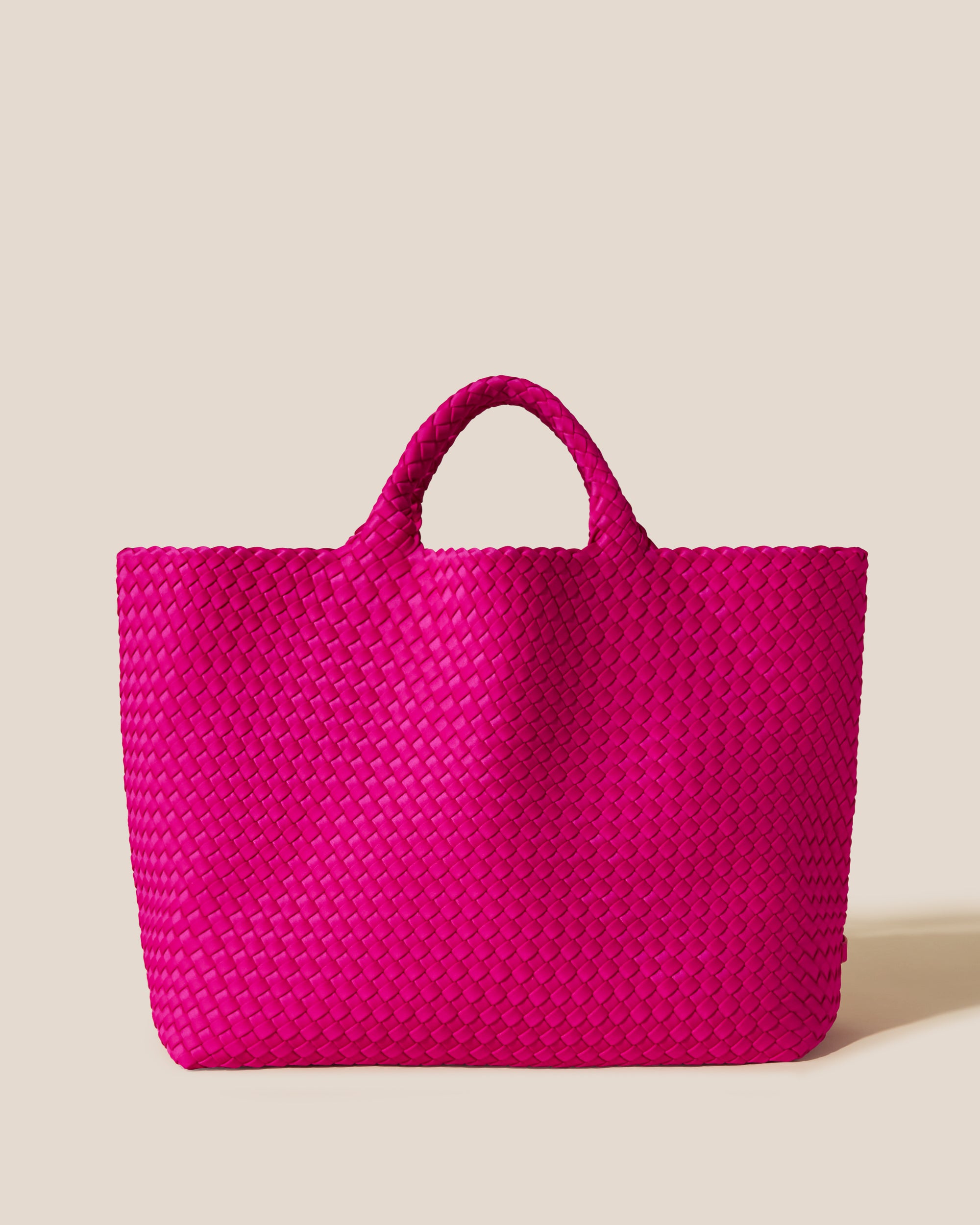 St. Barths Tote in Miami Pink, a vibrant pink tone, in handwoven neoprene, featuring an open top, and woven top handles.
