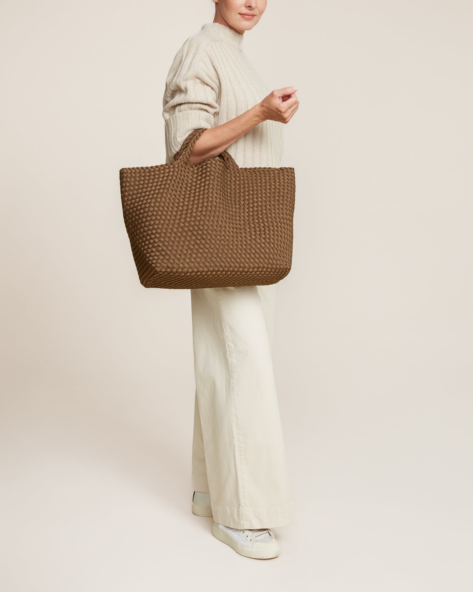 St. Barths Tote in Mink shown on model to illustrate scale and soft silhouette.