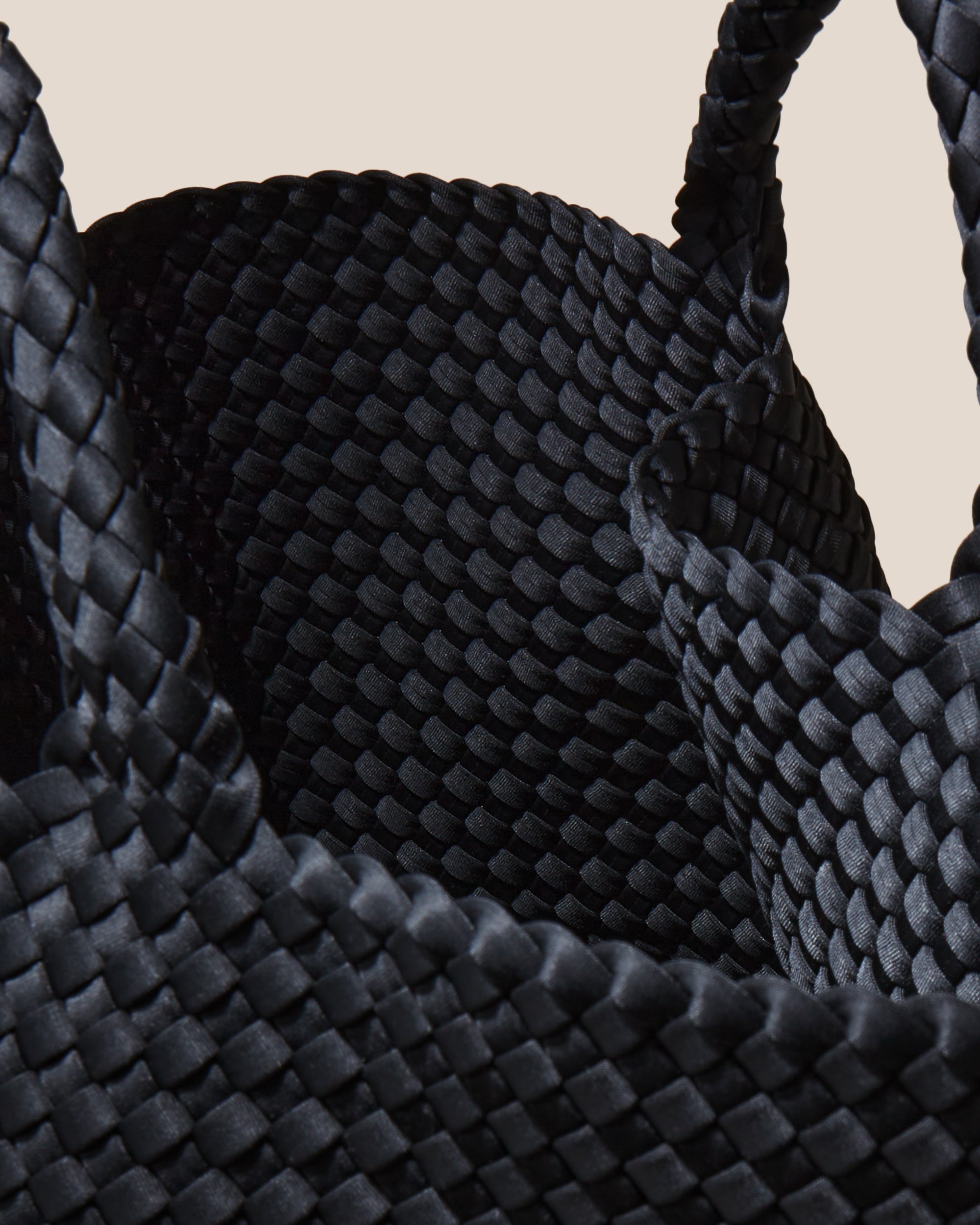 Interior close-up of St. Barths Tote in Onyx showing its open top, and unlined interior.