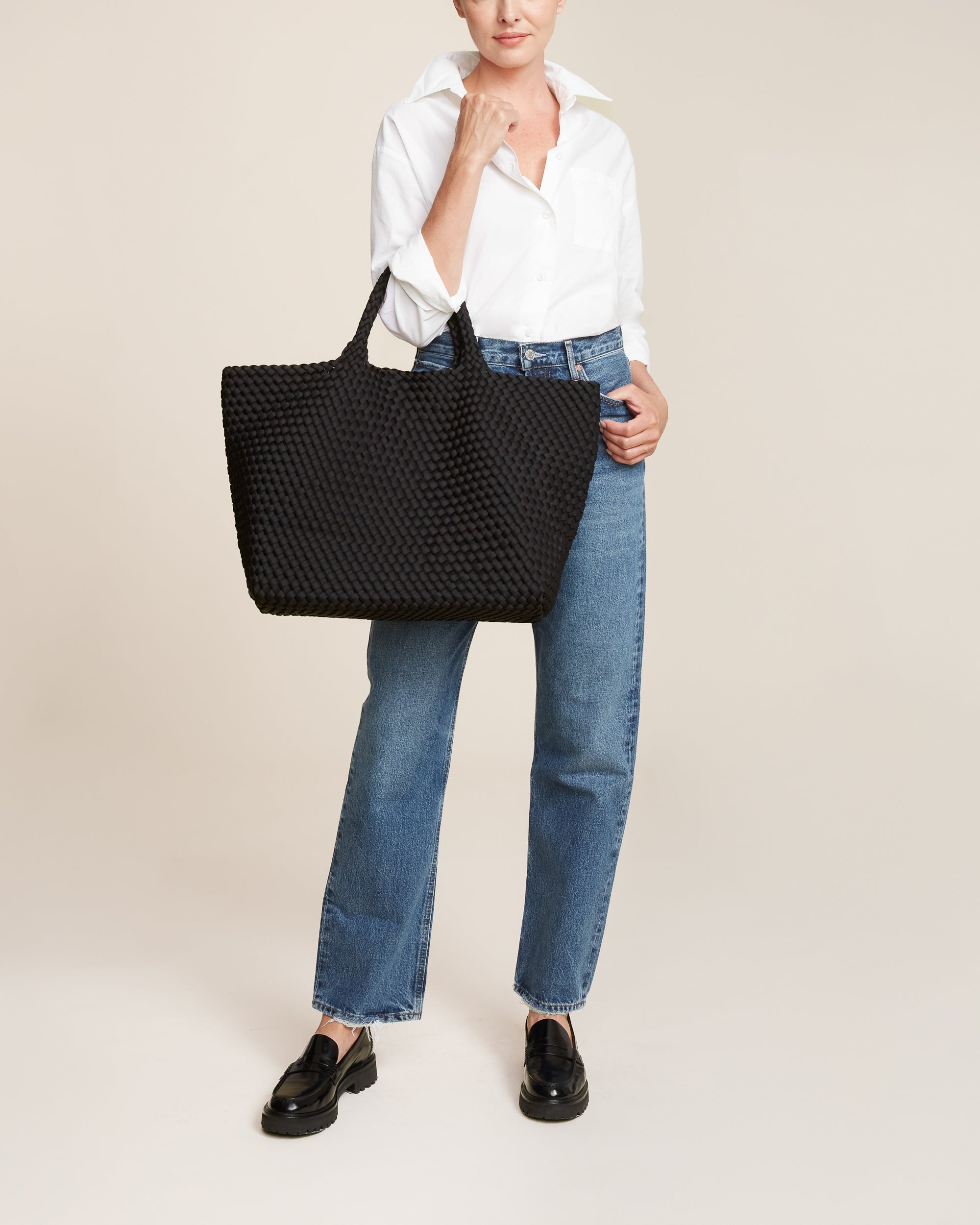 St. Barths Tote in Onyx shown on model to illustrate scale and soft silhouette.