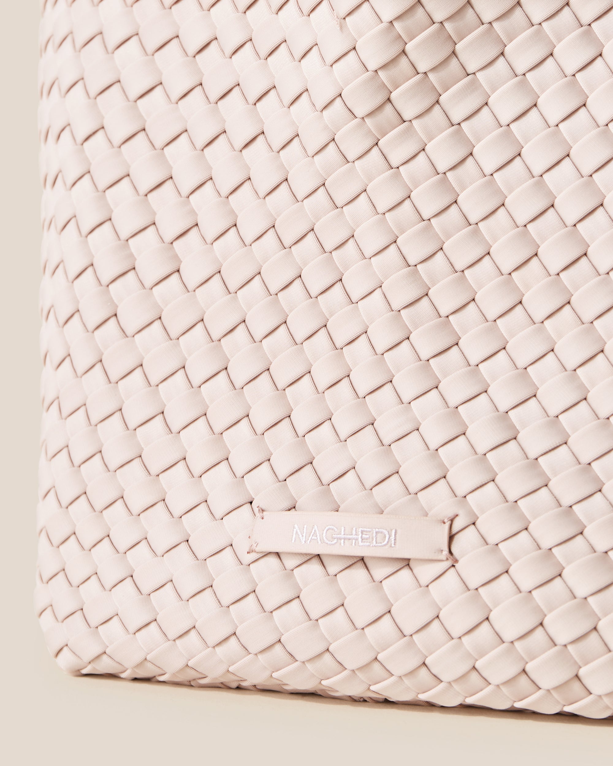 Close-up of stamped NAGHEDI logo on St. Barths Tote in Shell Pink.