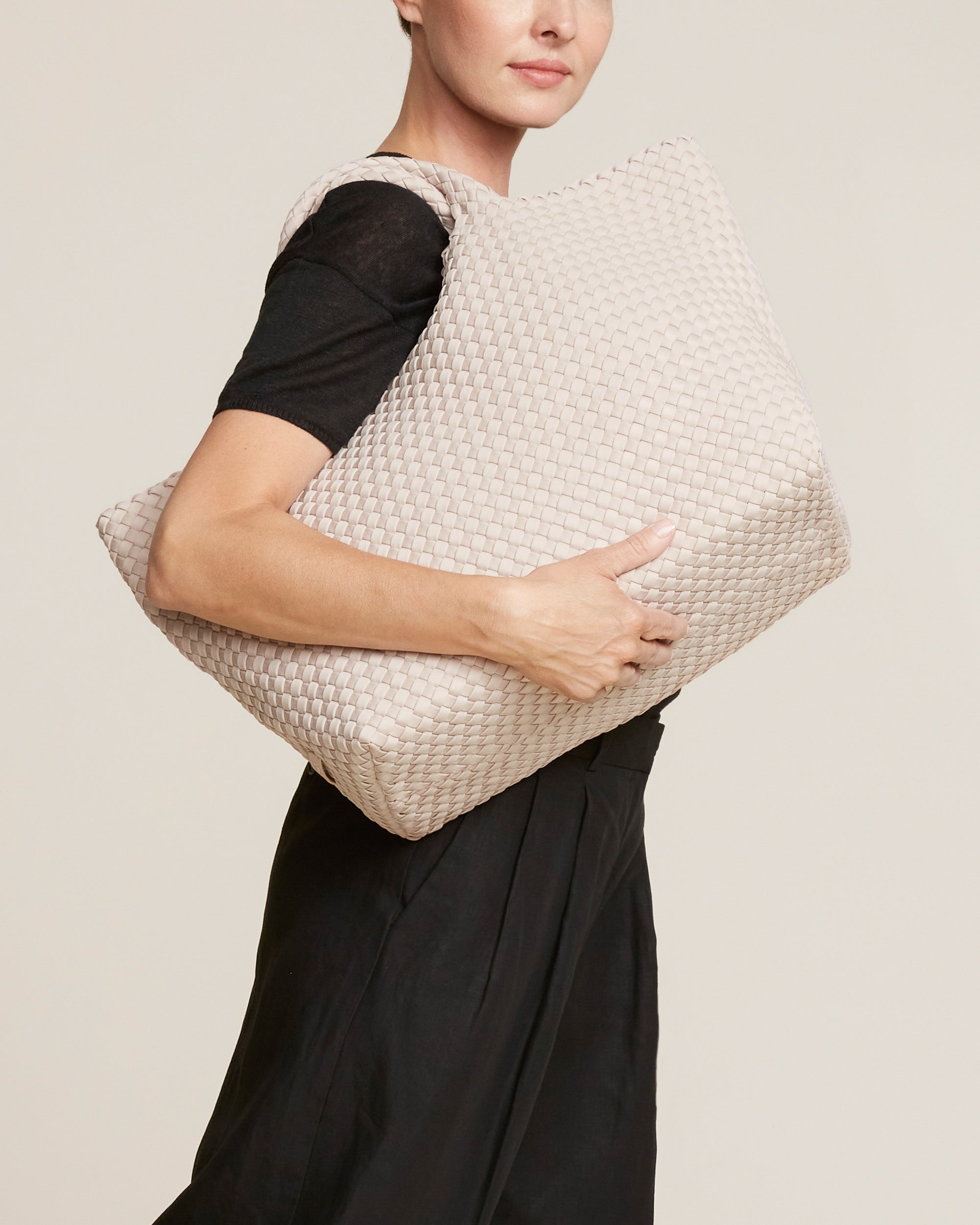 St. Barths Tote in Shell Pink shown on model to illustrate scale and soft silhouette.