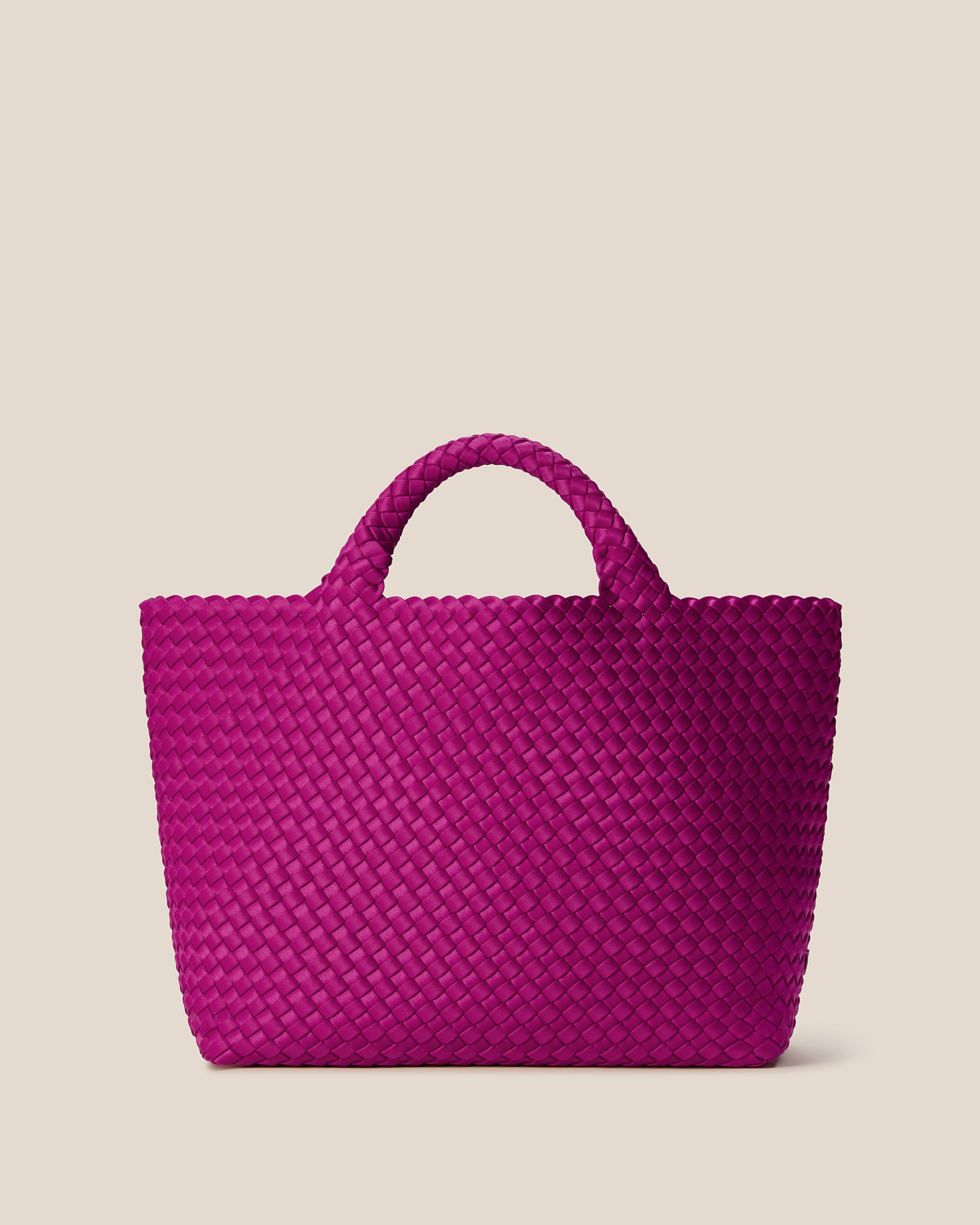 St. Barths Tote in Rio, a fuchsia tone, in handwoven neoprene, featuring an open top, and woven top handles.