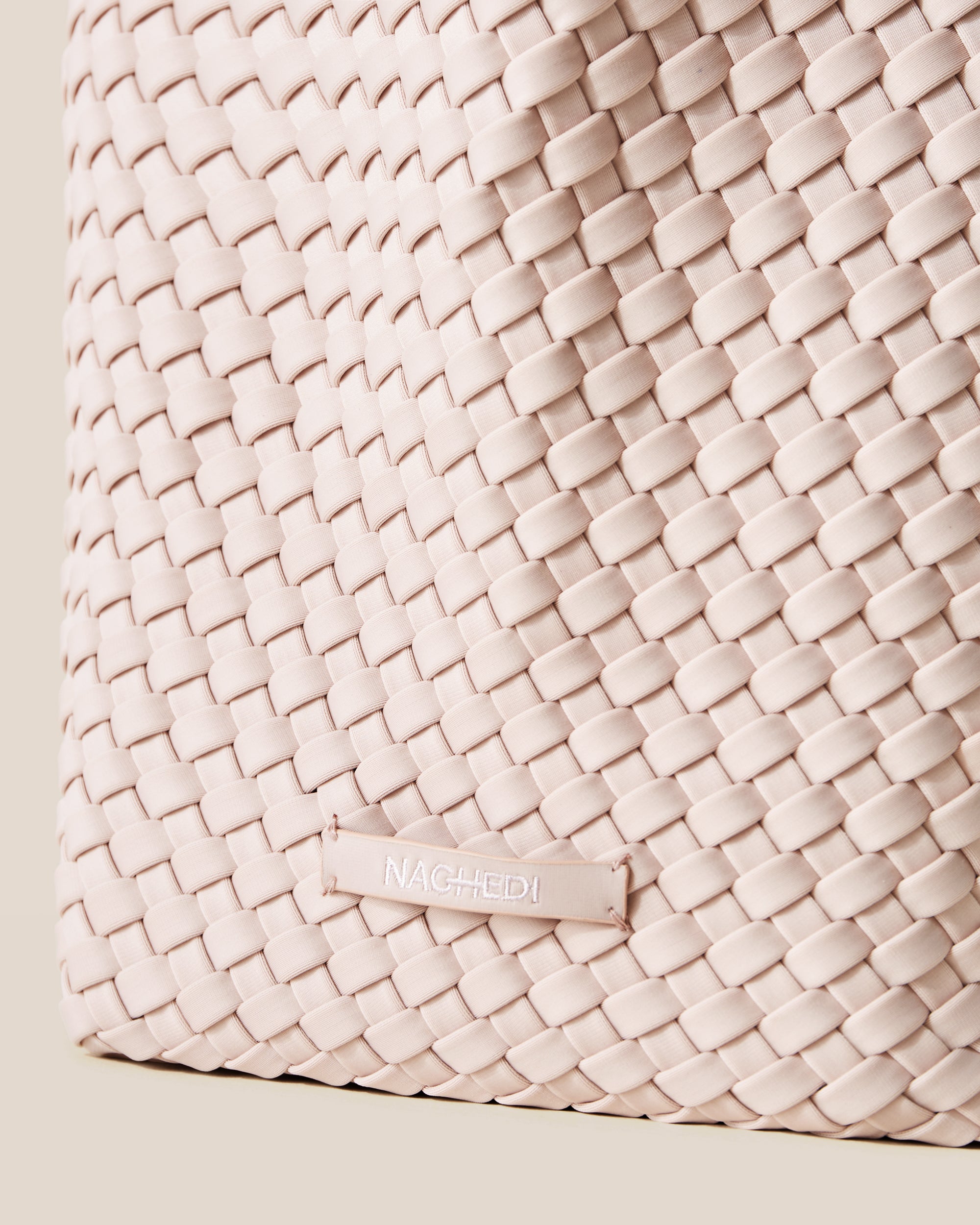 Close-up of stamped NAGHEDI logo on St. Barths Tote in Shell Pink.