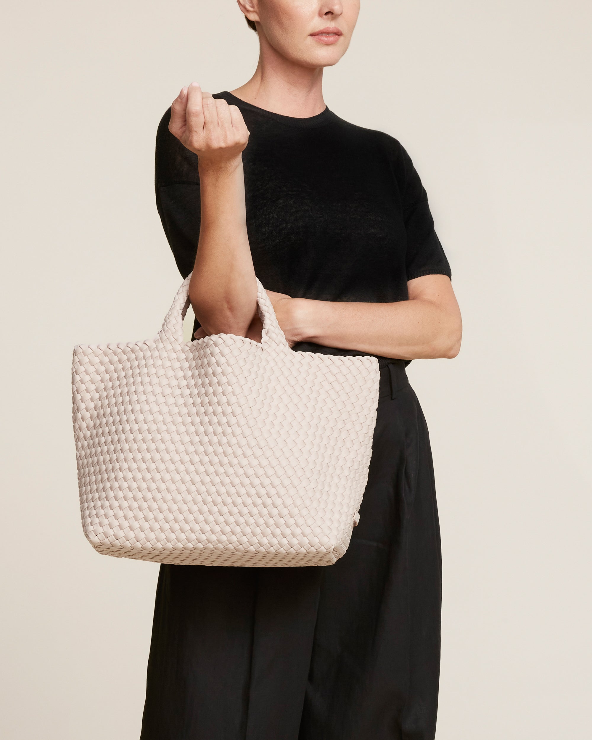 St. Barths Tote in Shell Pink shown on model to illustrate scale and soft silhouette.