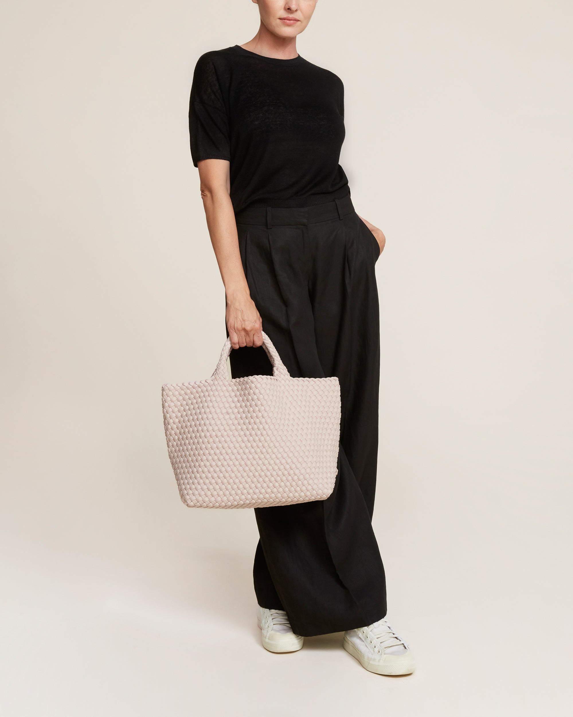 St. Barths Tote in Shell Pink shown on model to illustrate scale and soft silhouette.