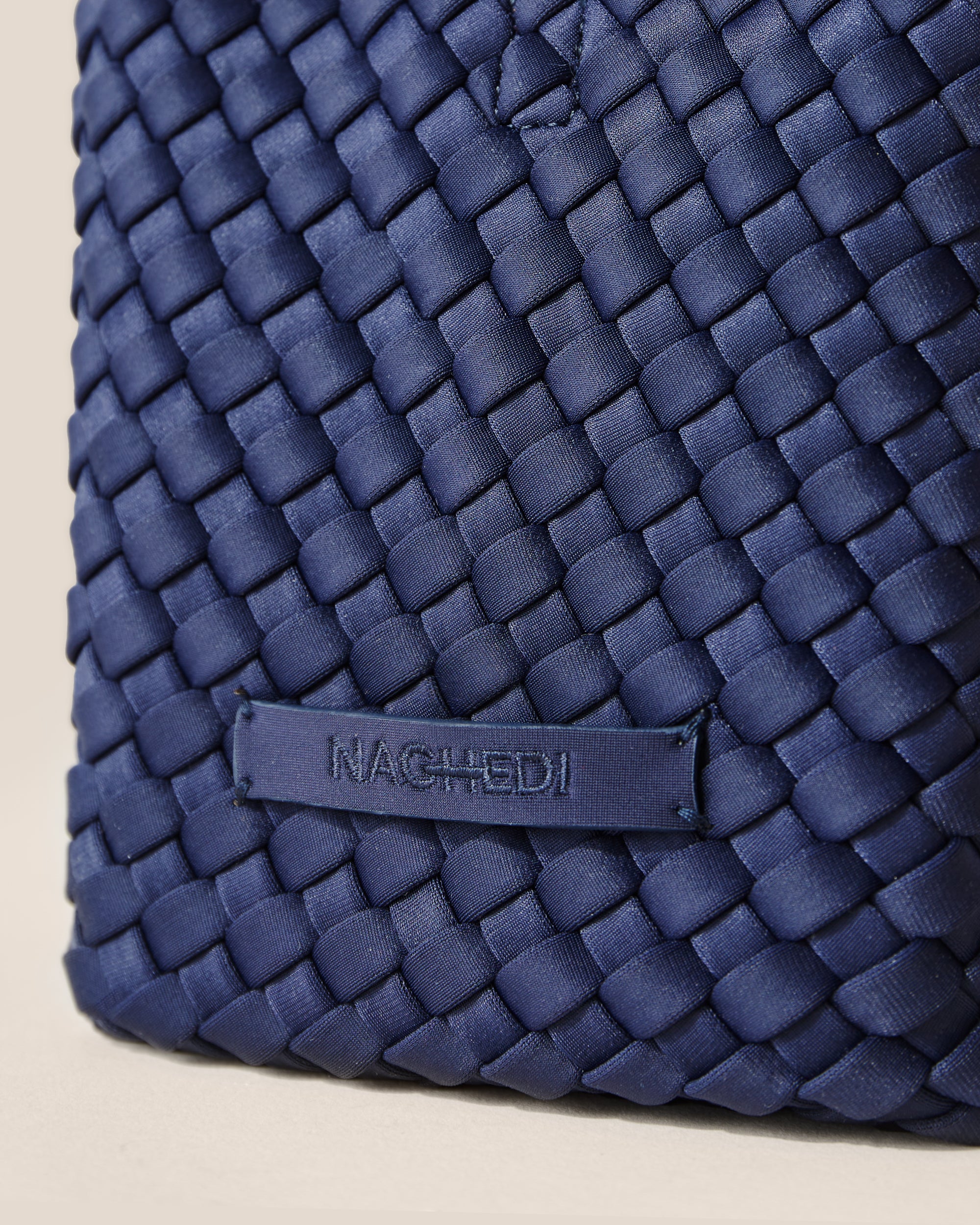 Close-up of stamped NAGHEDI logo on St. Barths Tote in Ink Blue.