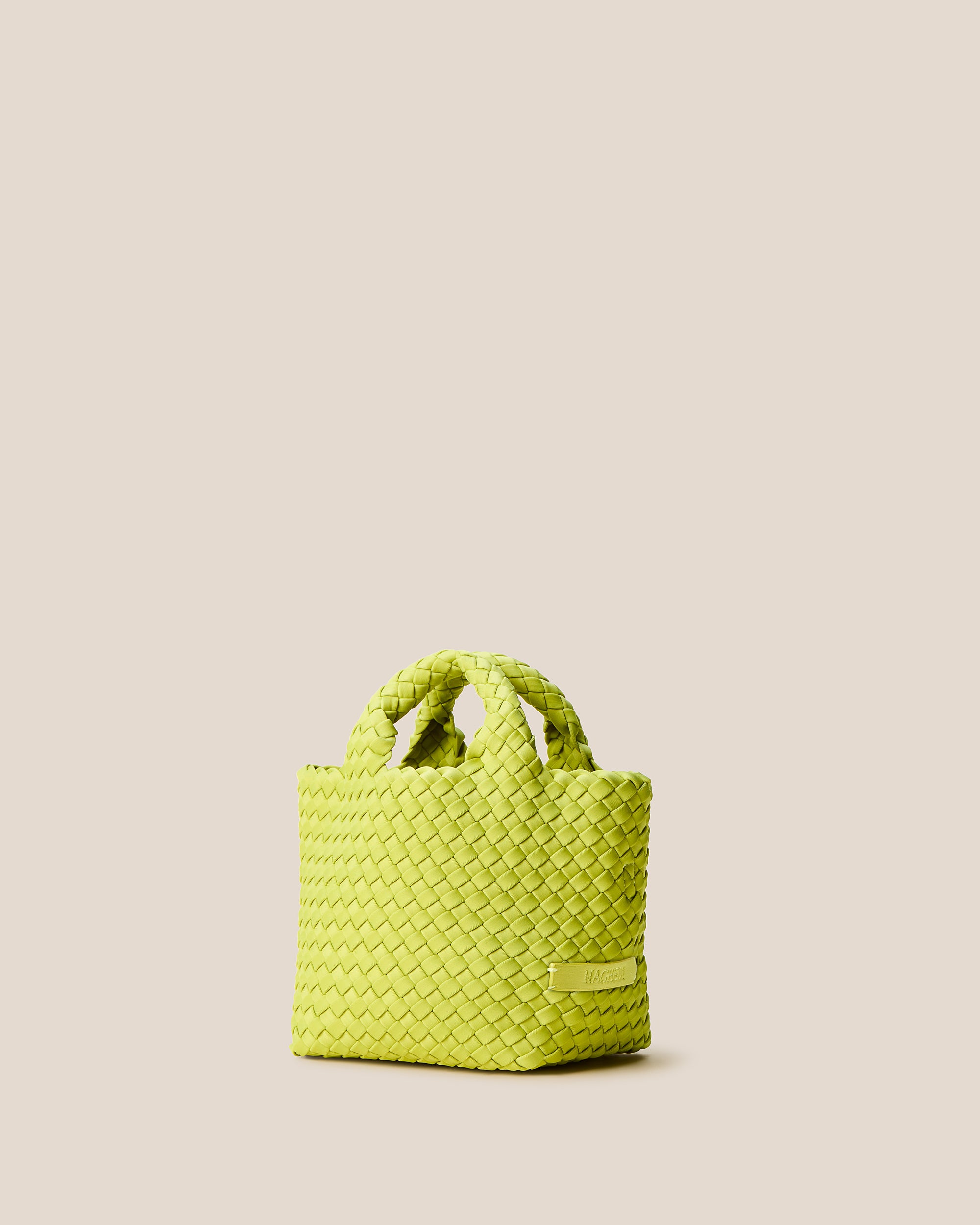 St. Barths Tote in Matcha shown from a side angle, highlighting its handwoven neoprene construction and open top.