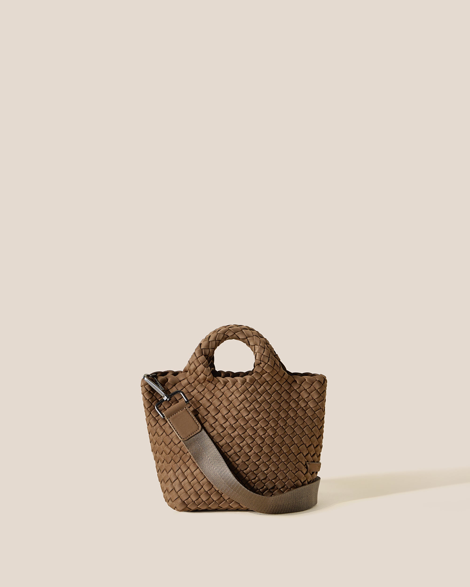 St. Barths Tote in Mink, a brown tone, in handwoven neoprene, featuring an open top, woven top handles, and detachable, adjustable nylon crossbody strap.