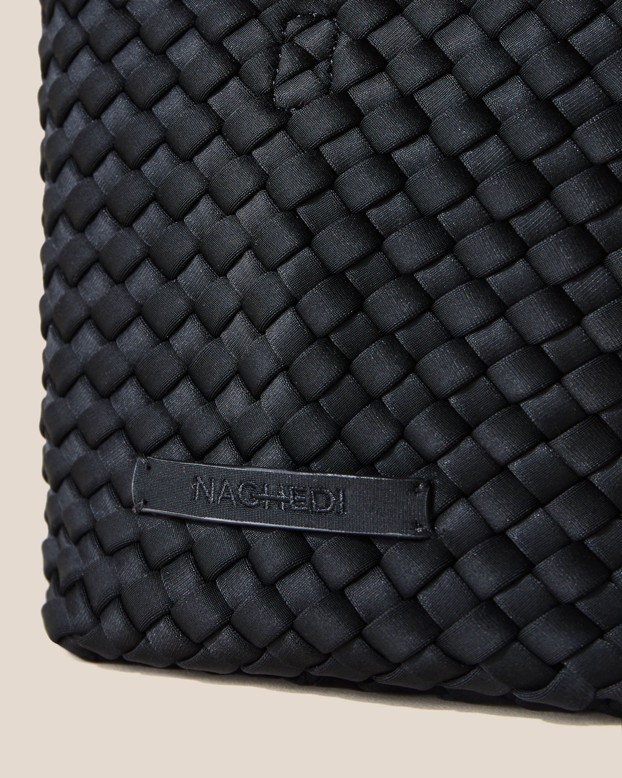 Close-up of stamped NAGHEDI logo on St. Barths Tote in Onyx.