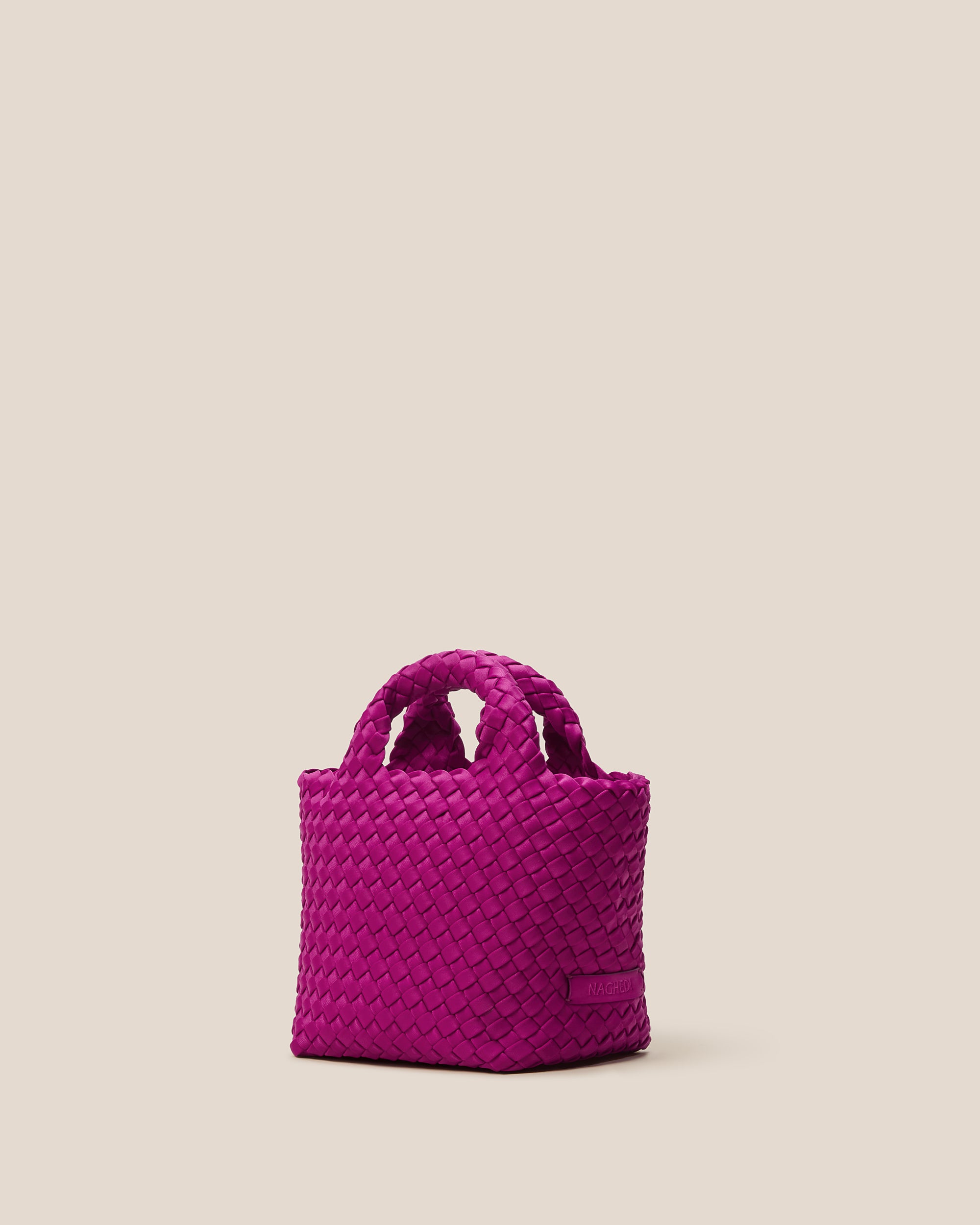 St. Barths Tote in Rio shown from a side angle, highlighting its handwoven neoprene construction and open top.