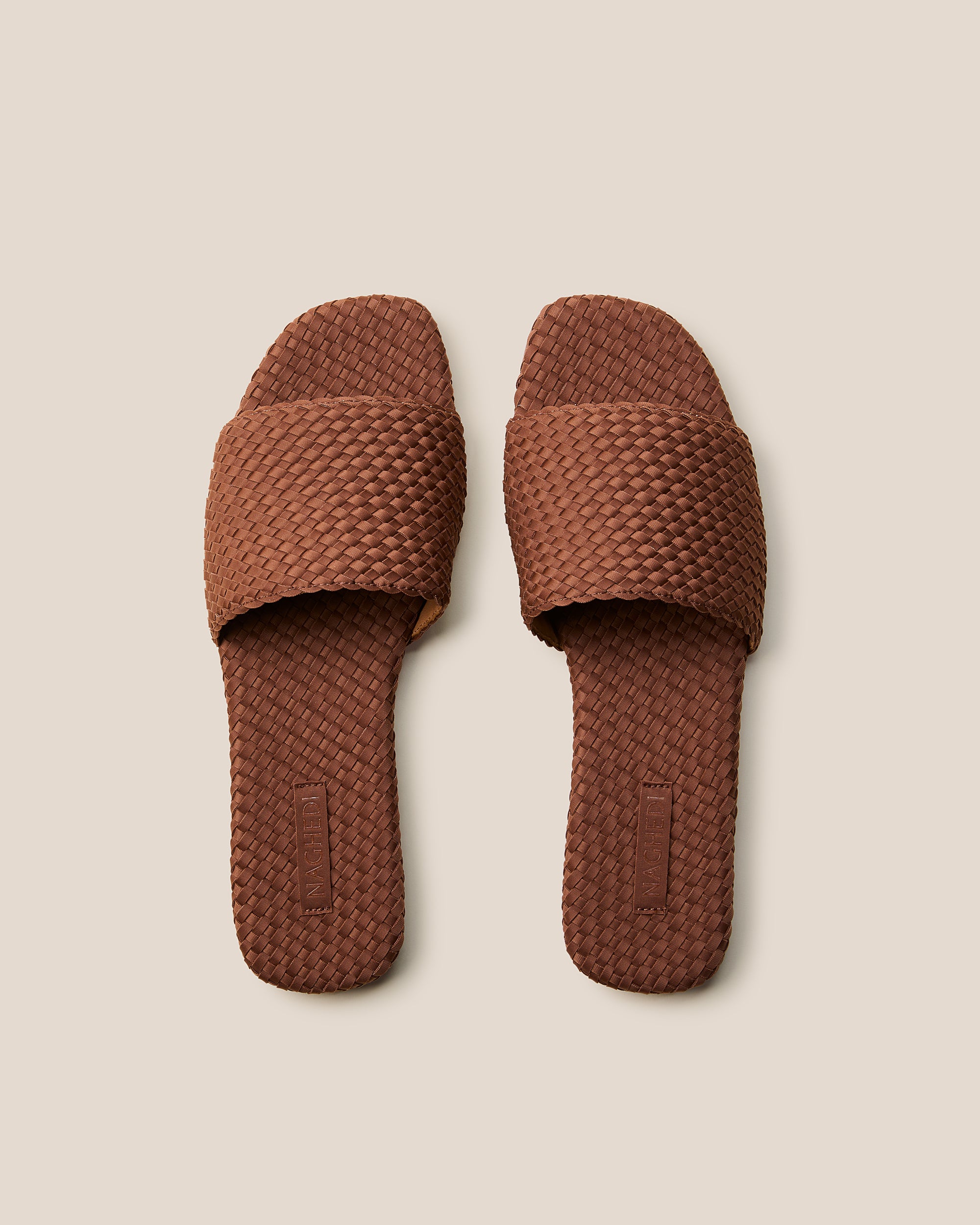 Top view of pair of The St. Barths Slide in Adobe showing the handwoven neoprene insole.
